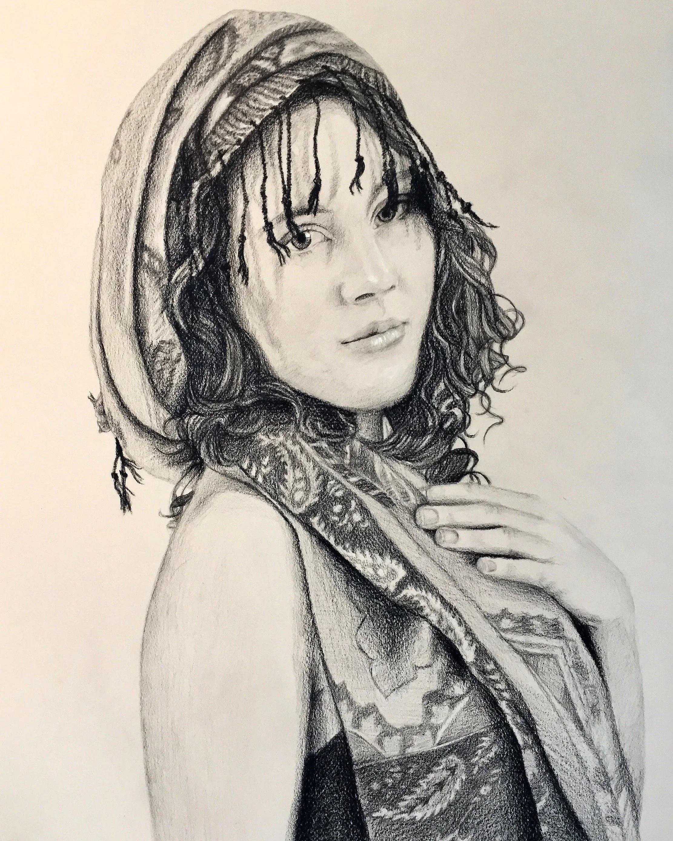 A detailed pencil sketch of a woman with long, curly hair, wearing a hooded garment and a patterned scarf, gazing softly to her right.