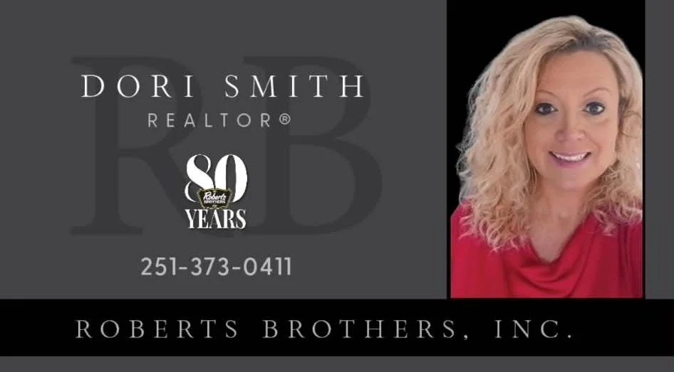 Business card for Dori Smith, a realtor celebrating 30 years with Roberts Brothers, Inc., featuring her photo, contact number, and company logo.