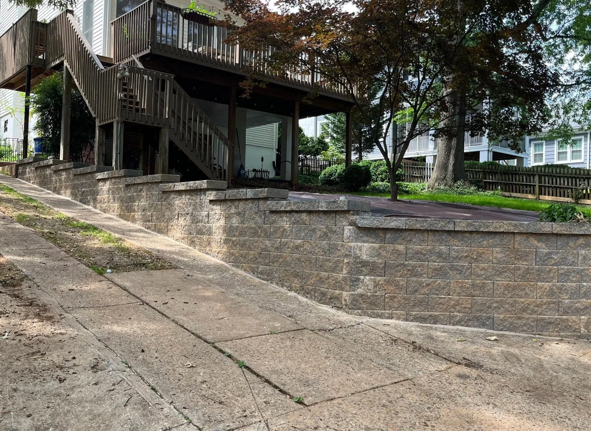 Newly installed multi-tier retaining wall that maximizes driveway area