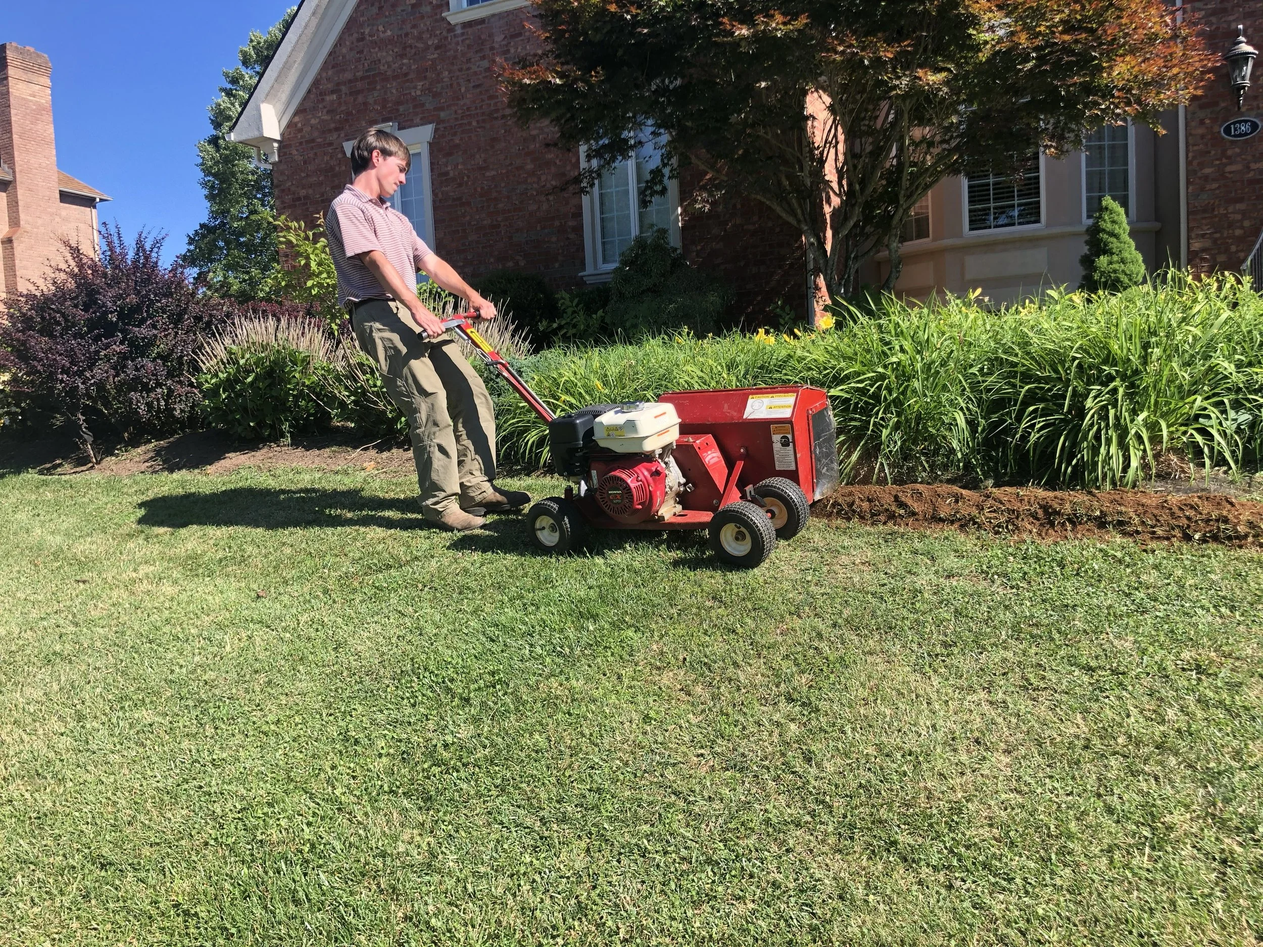 Oakwood Landscapes crew utilizing garden bed edger in Richmond