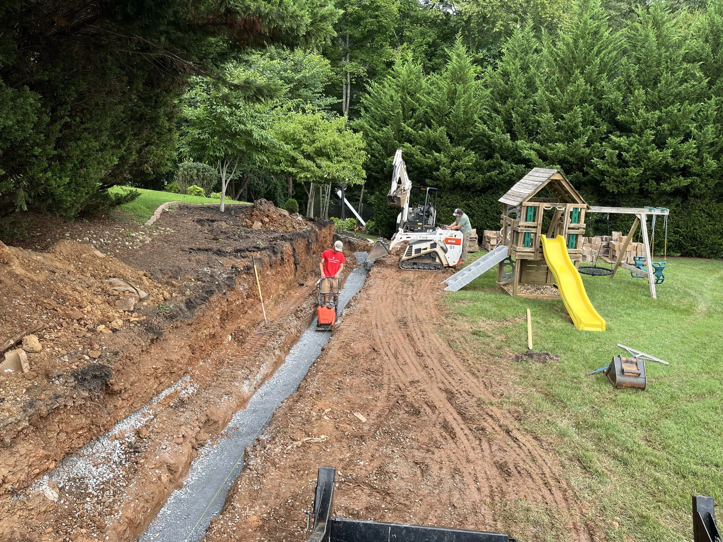 Oakwood landscapes crew constructing a new retaining wall