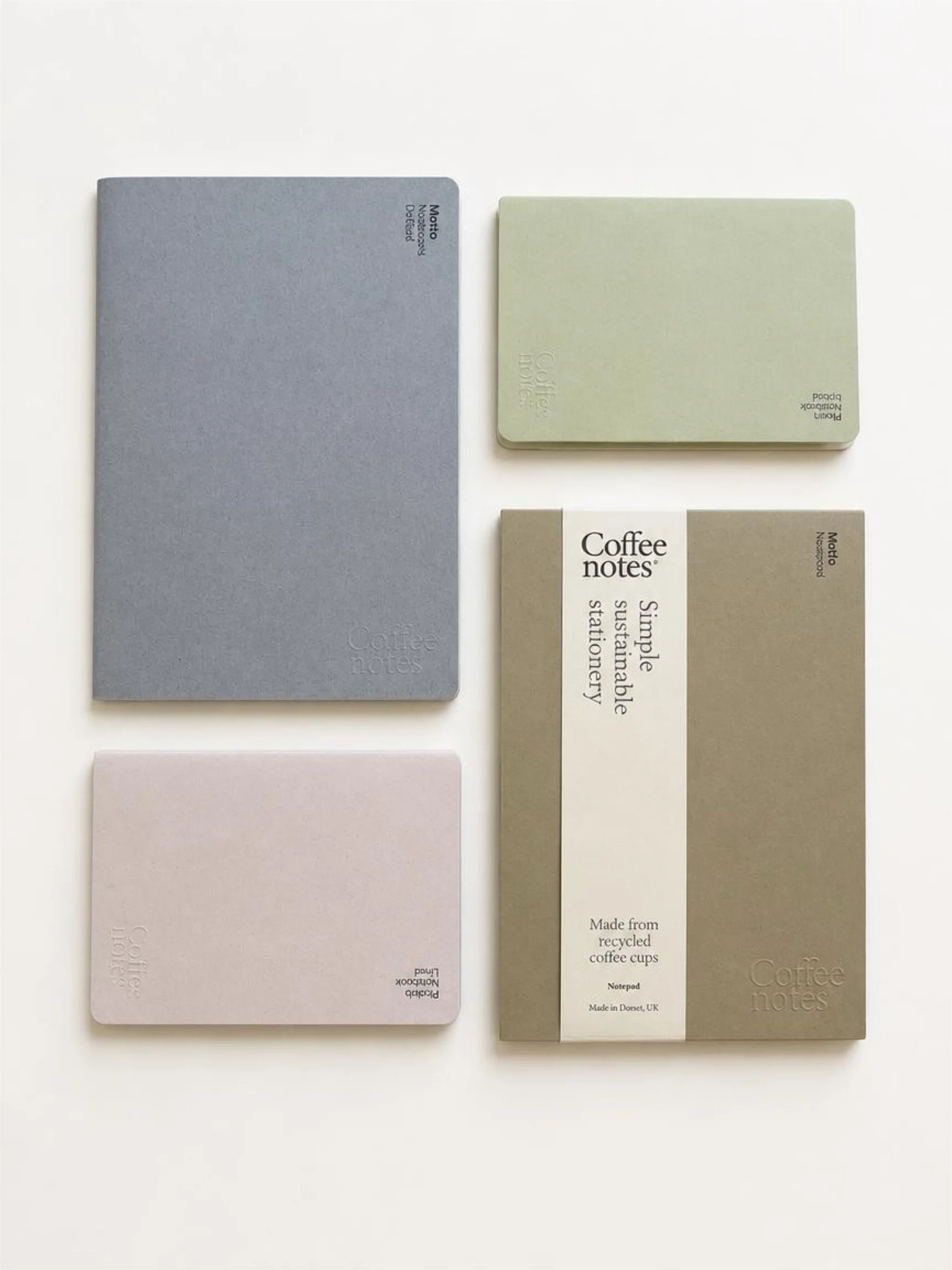 Four rectangular coffee notes in various pastel colors arranged on a white surface.