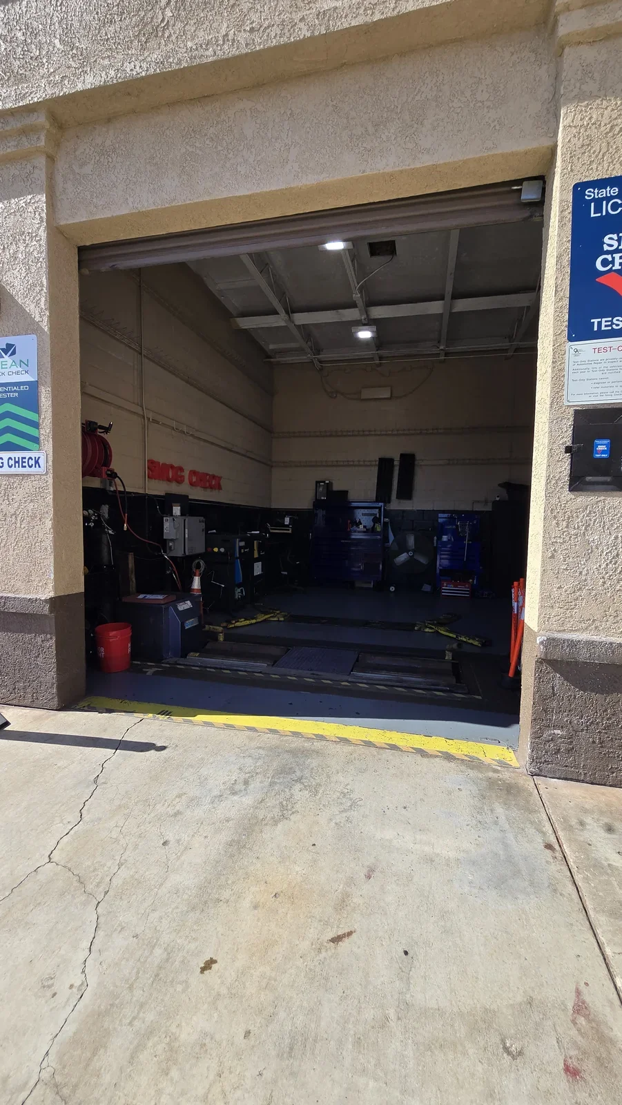 OC Smog Lab shop entrance and open smog-testing bay in Placentia