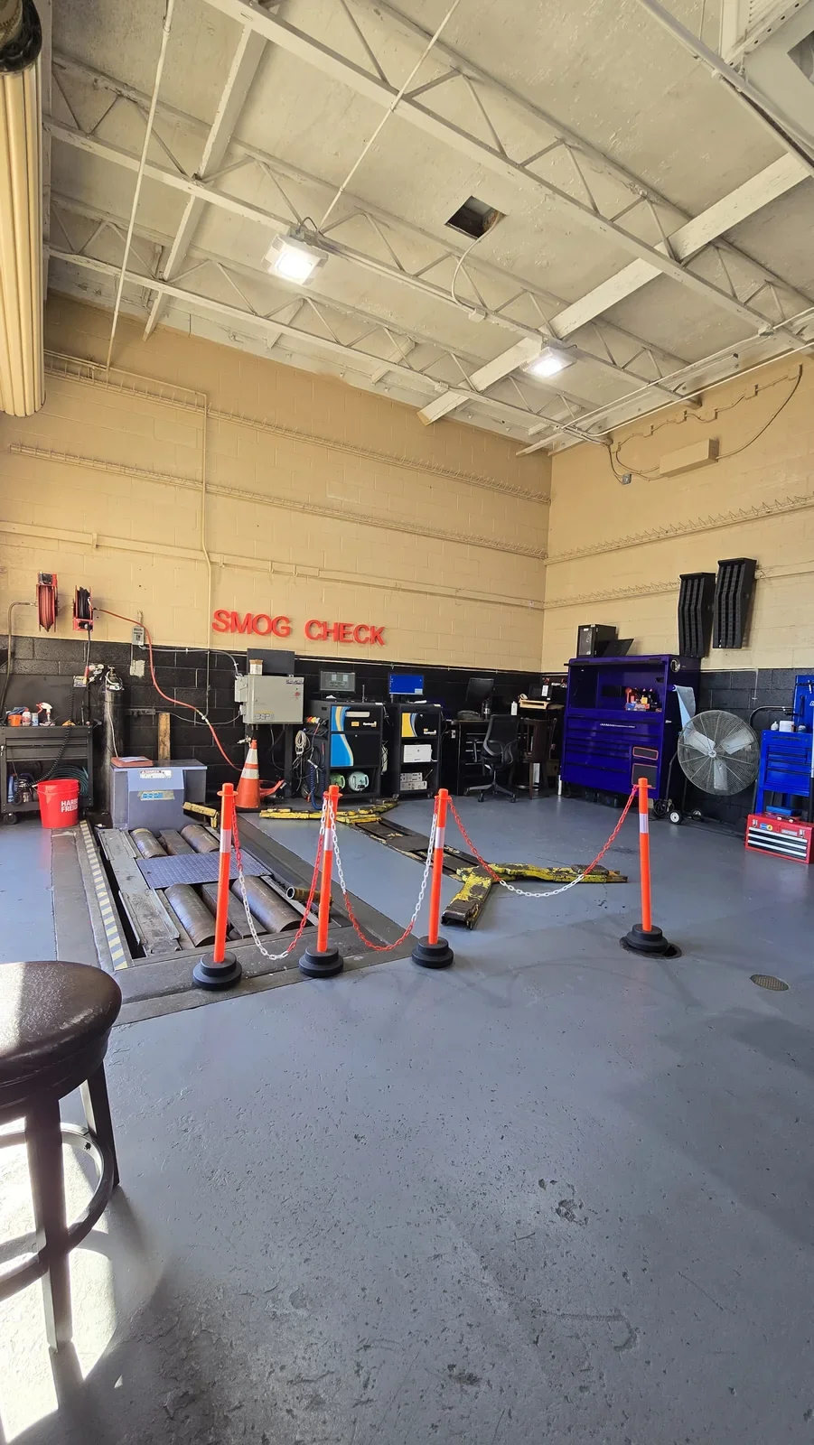 OC Smog Lab emissions testing bay with smog-check equipment and safety barriers