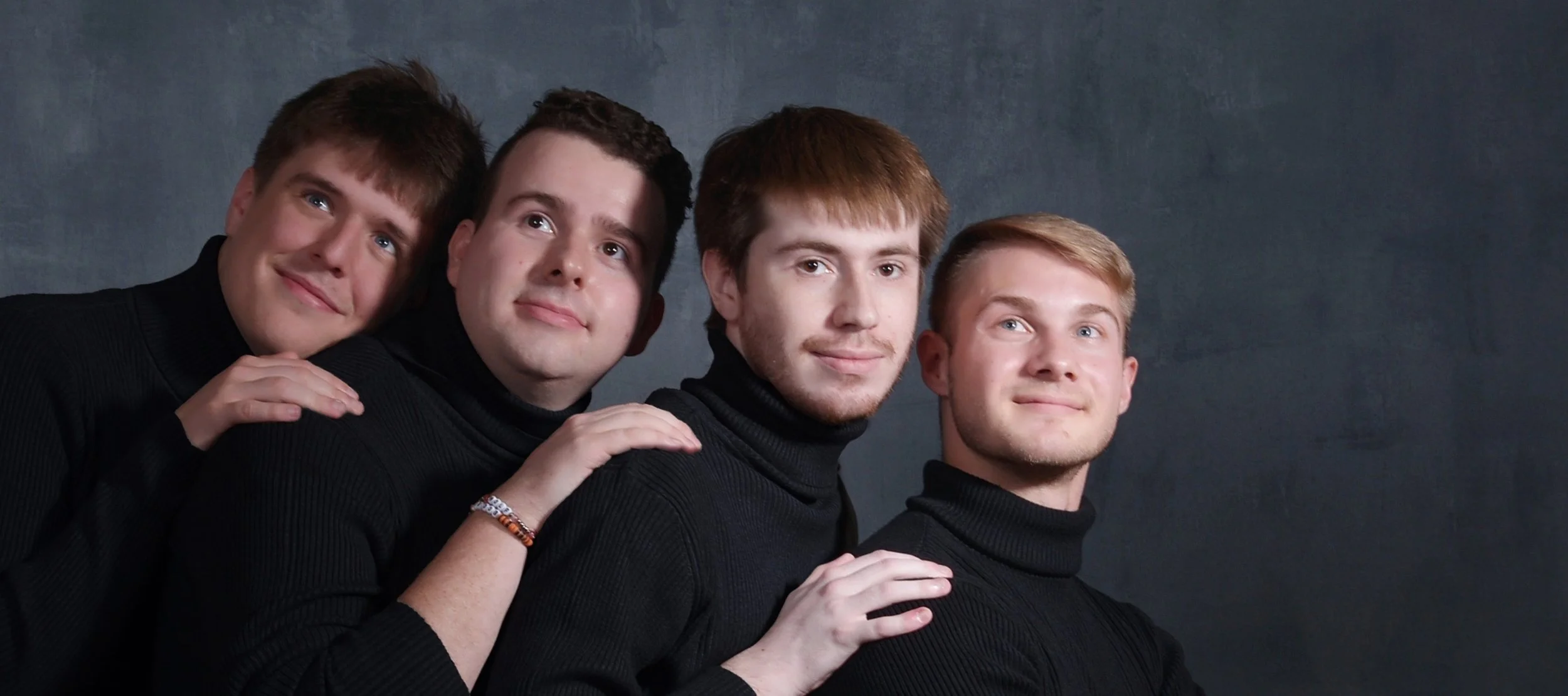 The four founding members of Static Apollo LLC posing together in black turtlenecks.