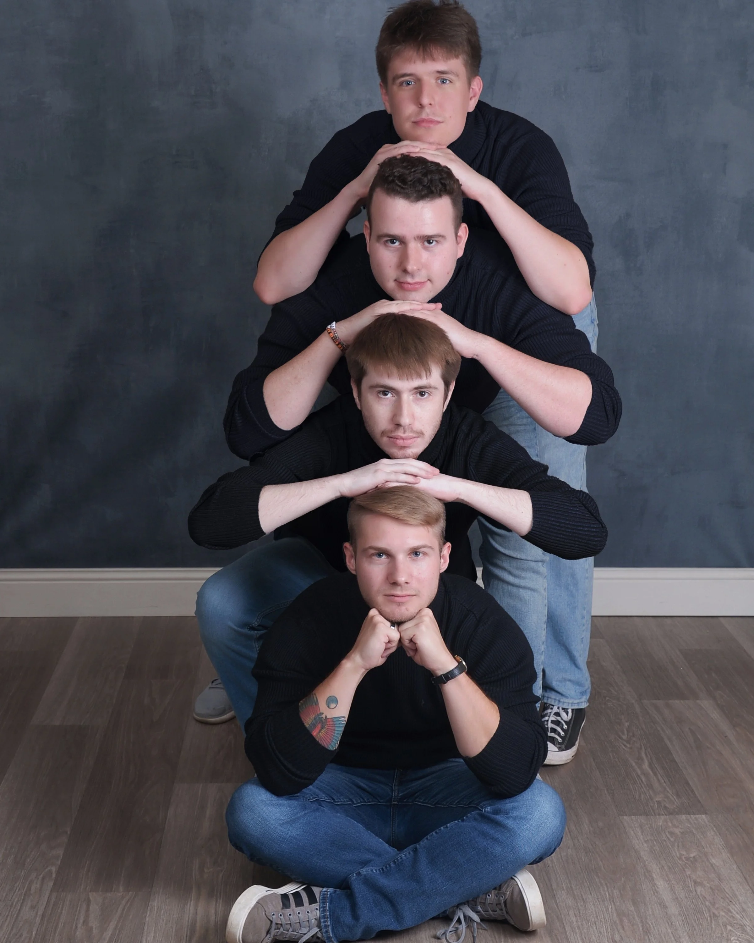 The four founders of Static Apollo LLC stacked vertically in a playful group portrait.