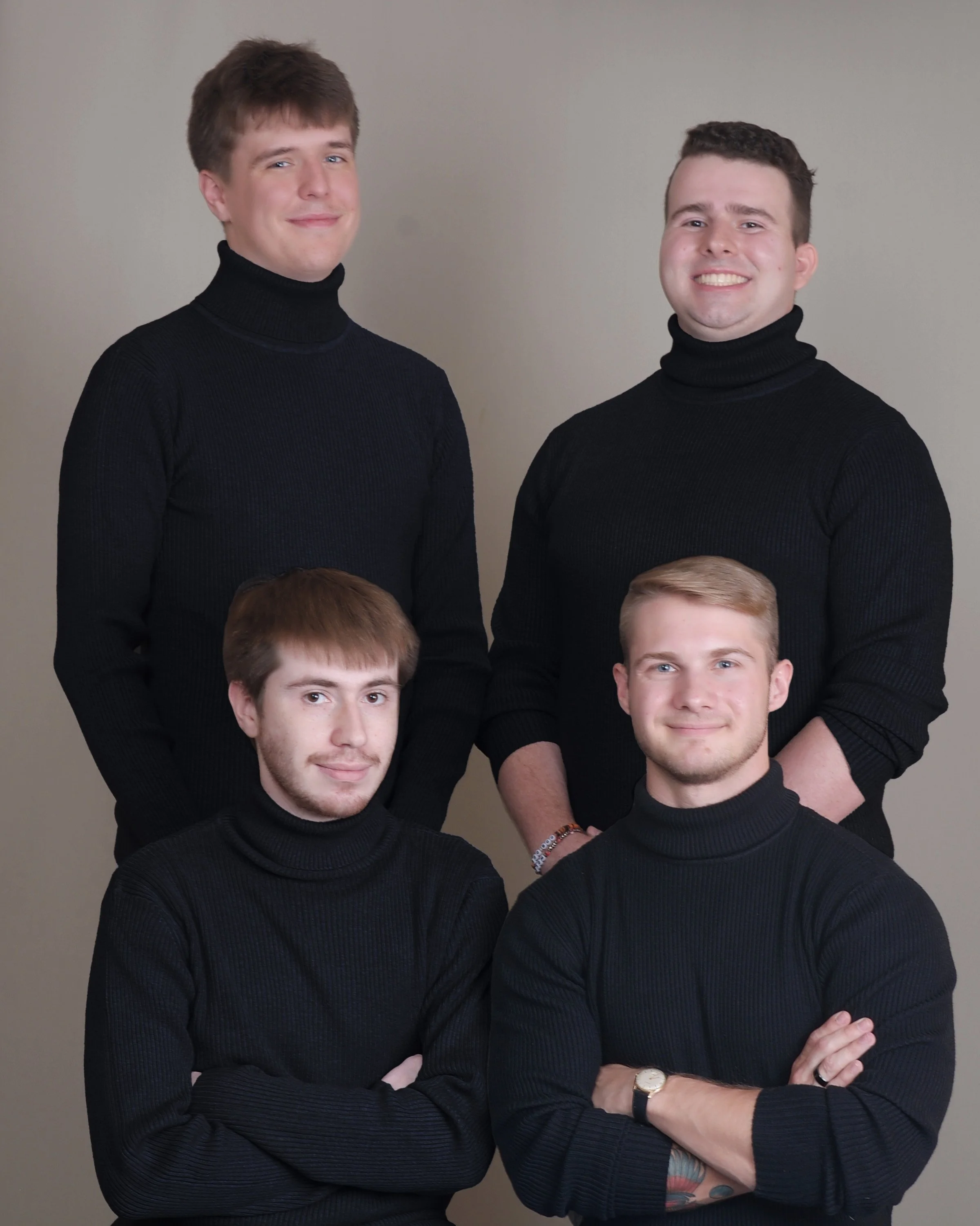 The four founding members of Static Apollo LLC posing for a studio portrait.