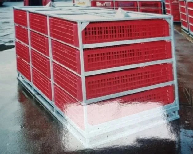 A pallet of red plastic crates stacked on a metal frame in a storage or distribution area.