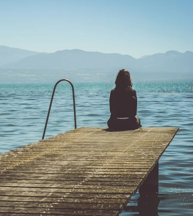 woman sitting on a dock