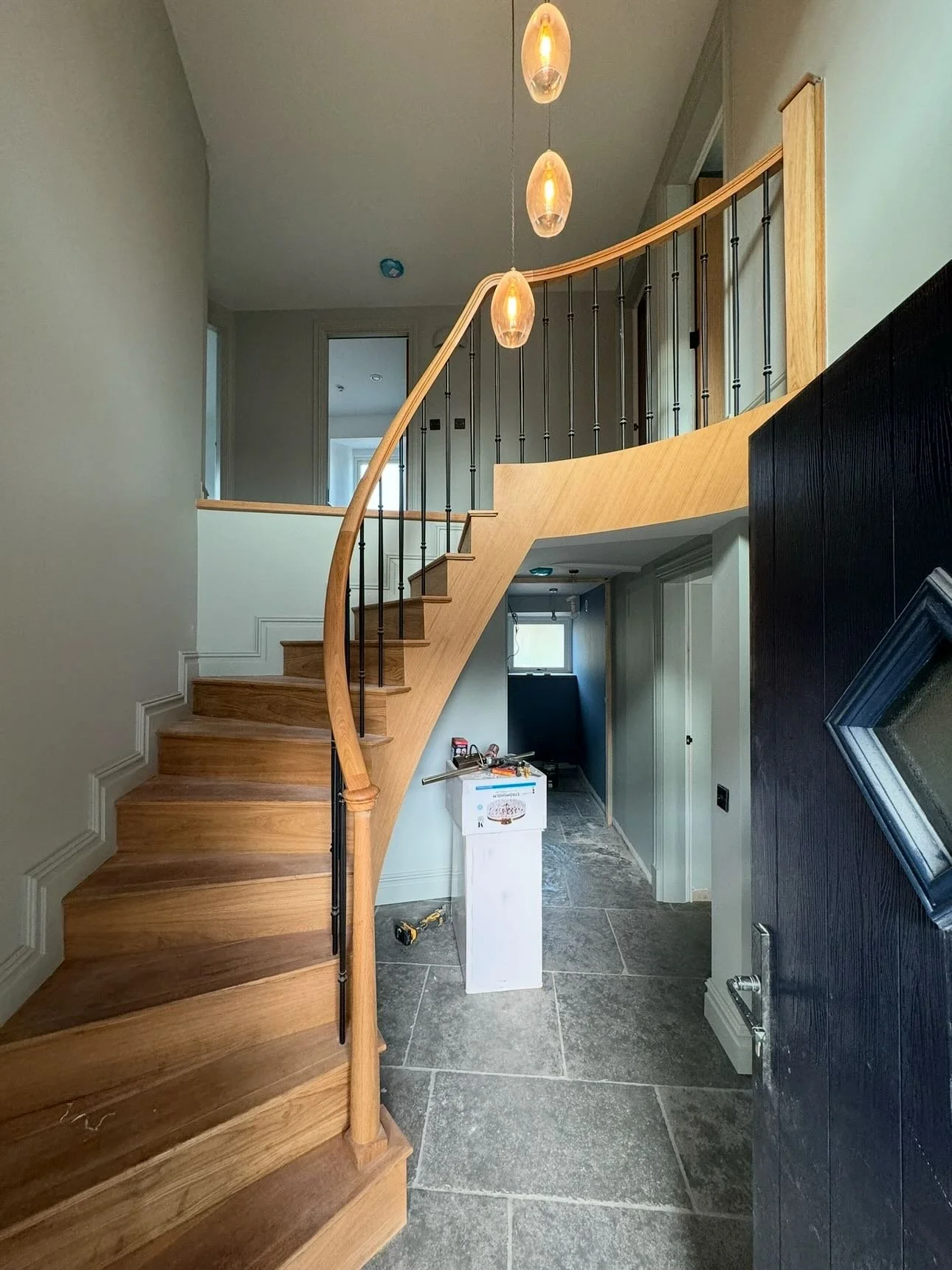 Entrance hallway and upstairs now finished. The curved oak staircase is a real showstopper when you walk through the front door