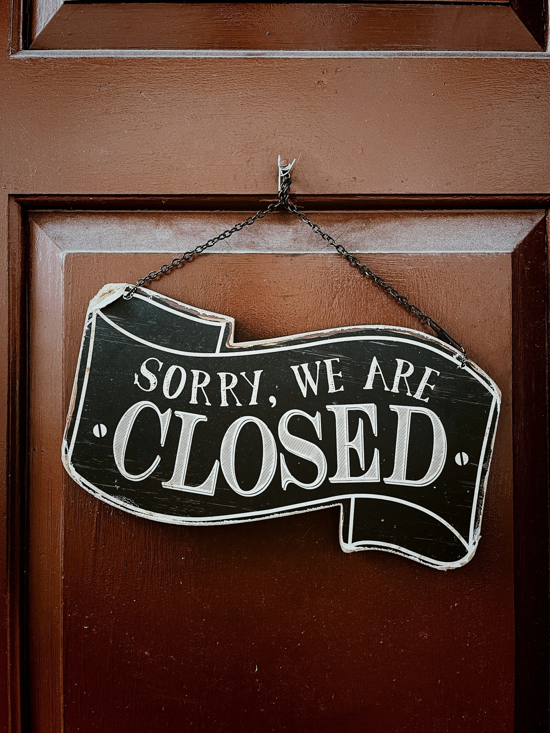 A chalkboard-style sign hanging on a door with a chain. The sign reads, 'Sorry, we are closed.' Immigration UK England Hertfordshire Berko Berkhamstead Art art artist local places to see things to do mermaids original charcoal drawing oil painting