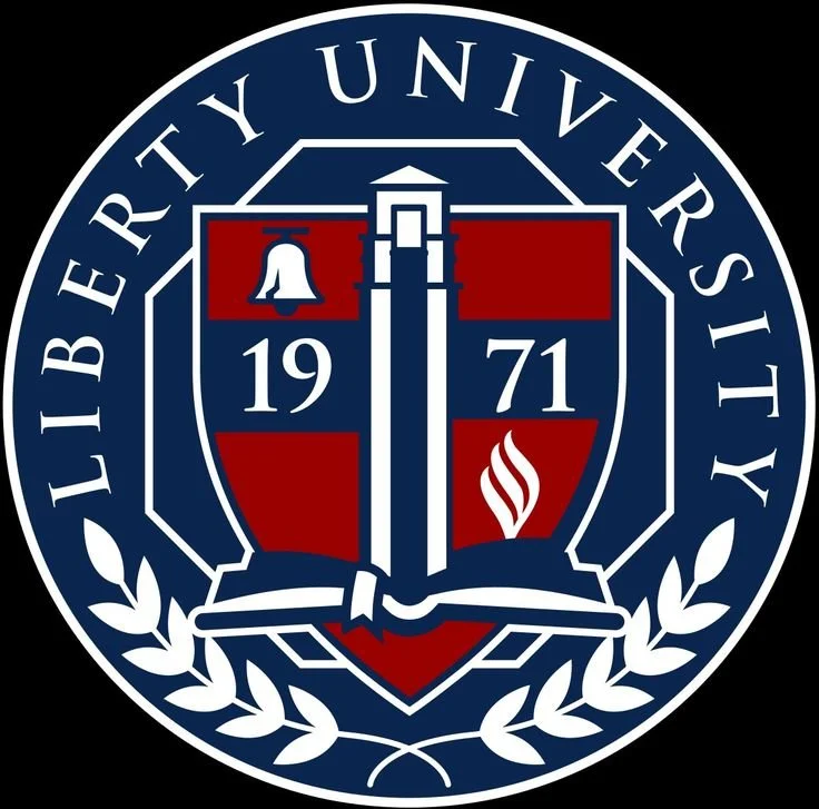 Seal of Liberty University featuring a shield with a bell, torch, and open book, surrounded by the text 'Liberty University' and decorative laurel branches.
