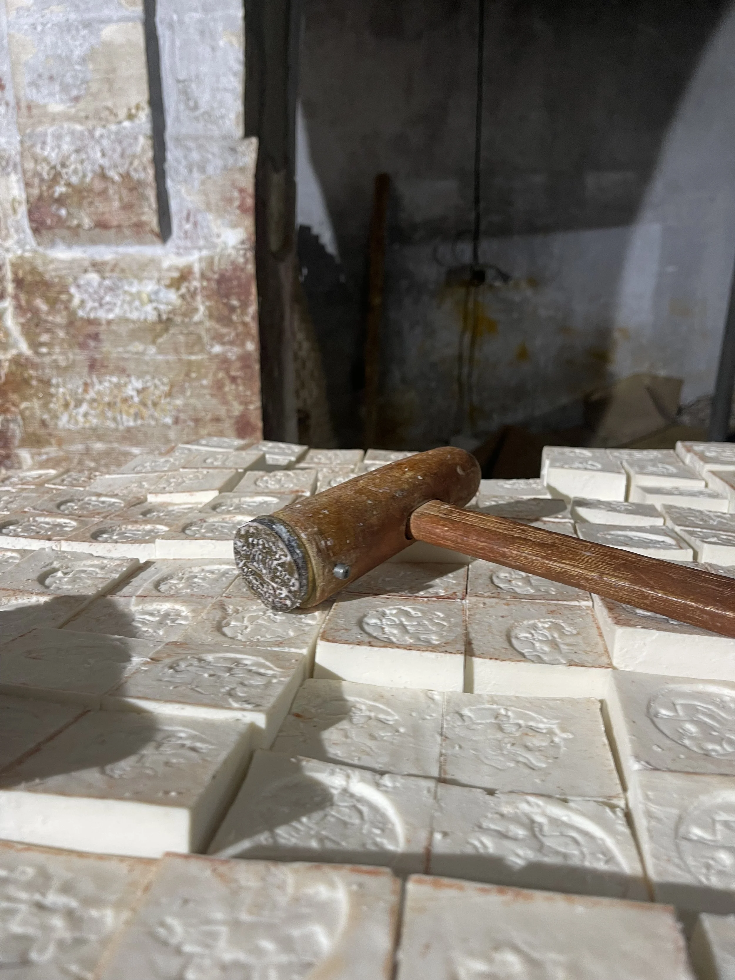 Close-up of logo hammer, mounted on Al-Jamal Nabulsi Olive Oil Soap Bars.