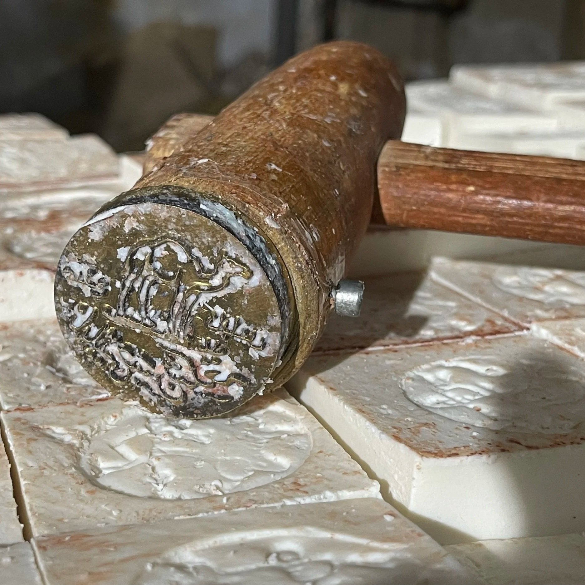 Close-up of logo hammer, mounted on Al-Jamal Nabulsi Olive Oil Soap Bars.