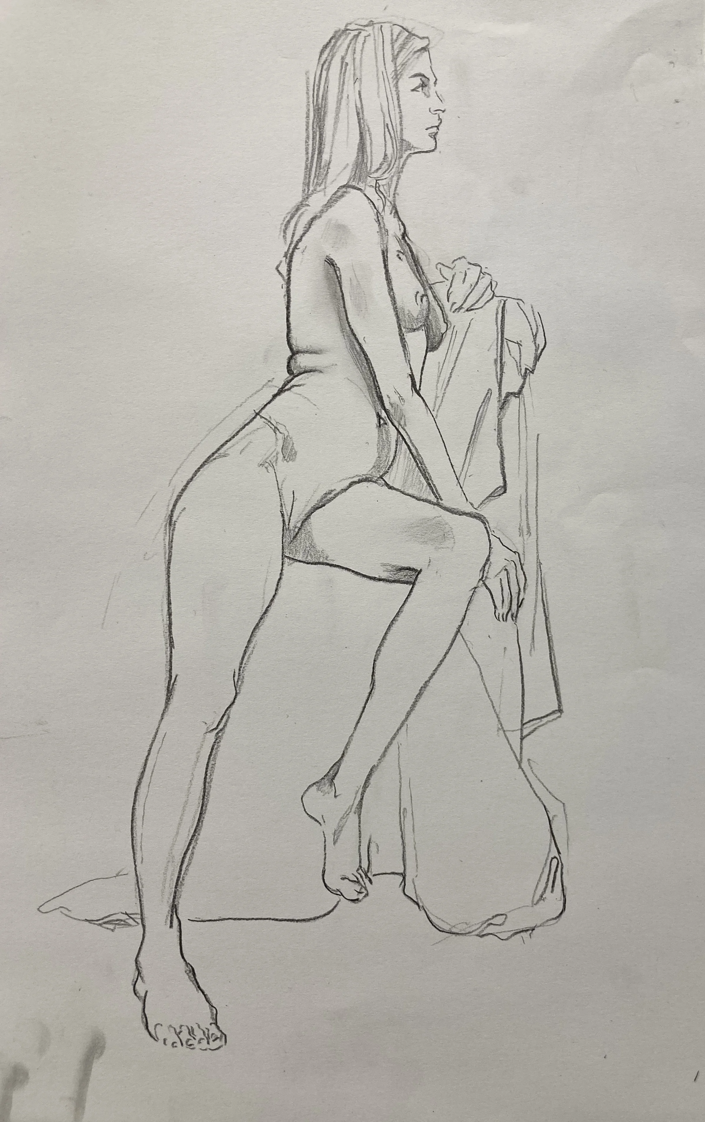 A pencil sketch of a woman sitting on a chair, with her right leg crossed over her left, and her left hand resting on her knee. She has long hair and wears a casual shirt and shorts.