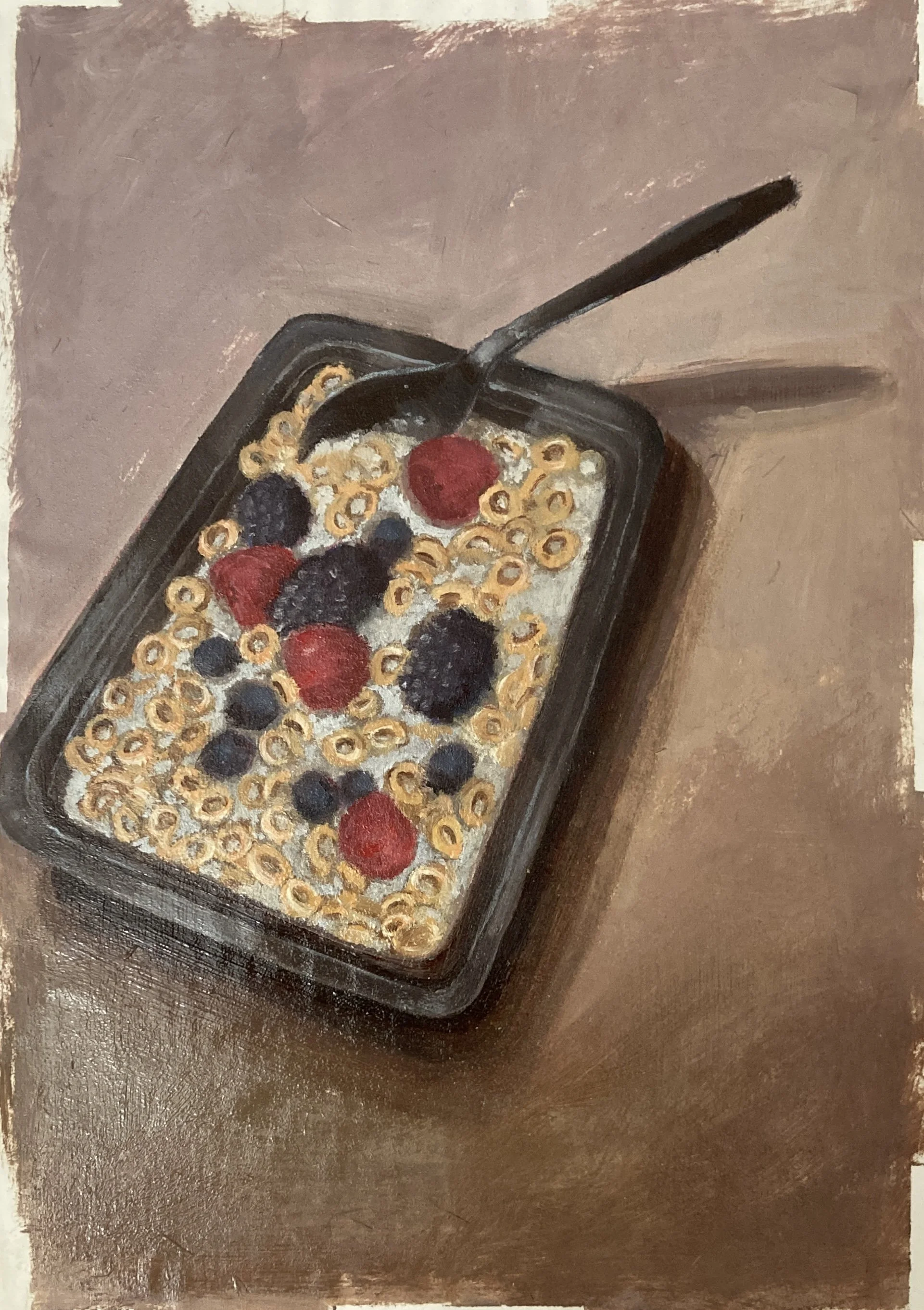 A black tray filled with cereal, topped with fresh berries including raspberries and blueberries, with a black spoon resting on the side of the tray.