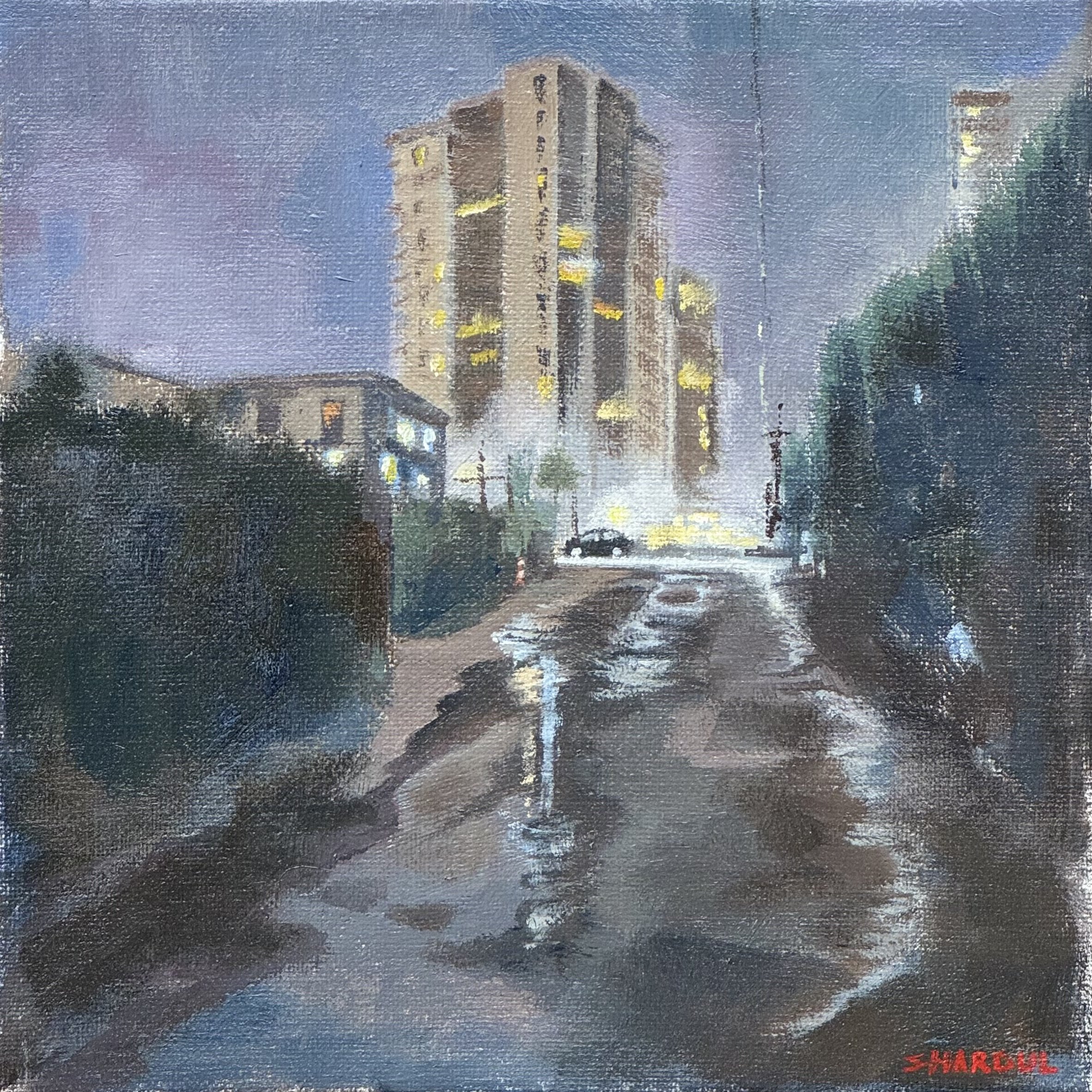 A painting of a tall high-rise building at night with lit windows against a dark sky, and a smaller building in the foreground, with the artist's signature 'SHARCEL' in red in the bottom right corner.