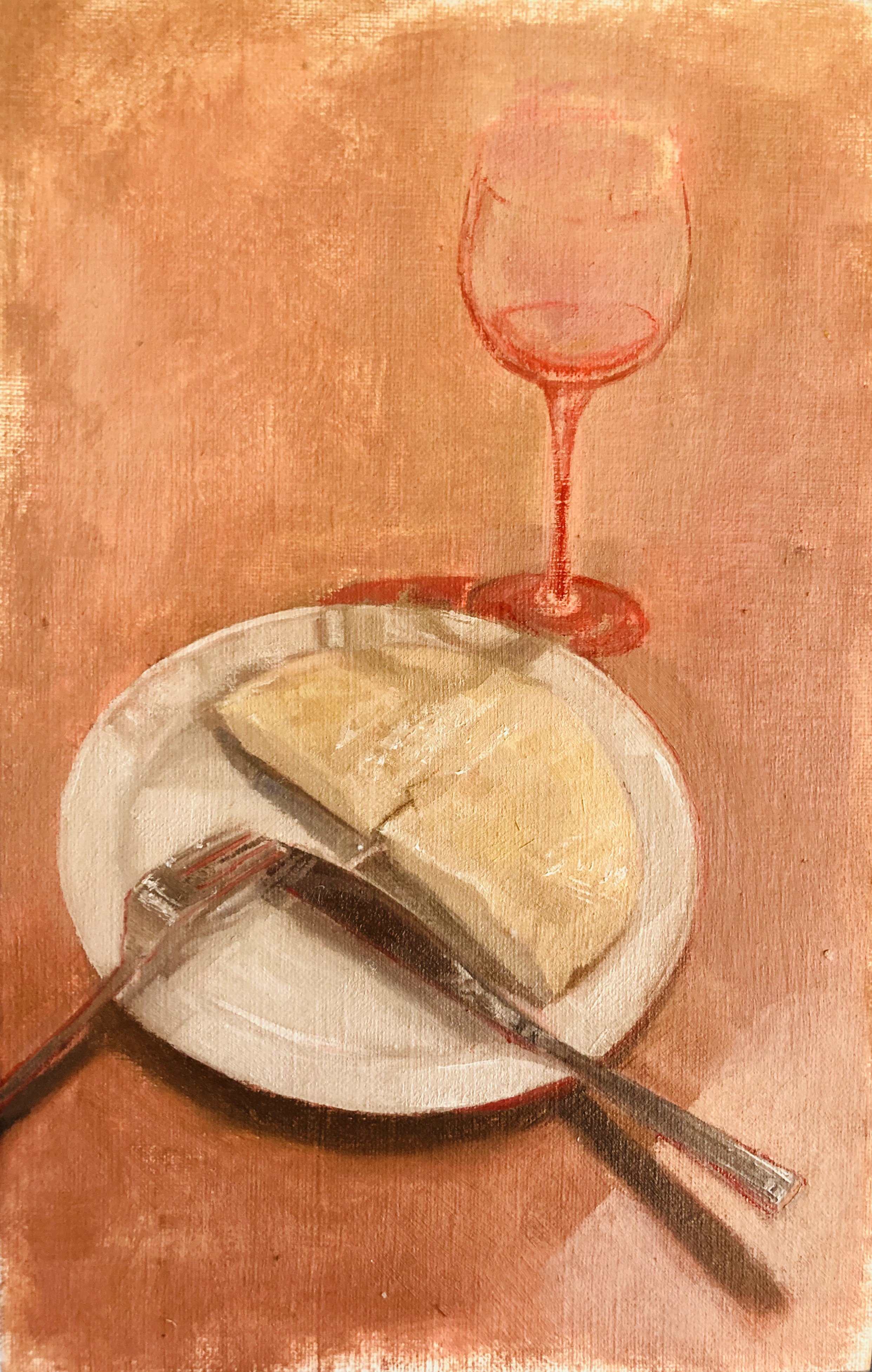 A plate with a wedge of cheese, a fork, and a knife, with a glass of white wine in the background on a wooden table.