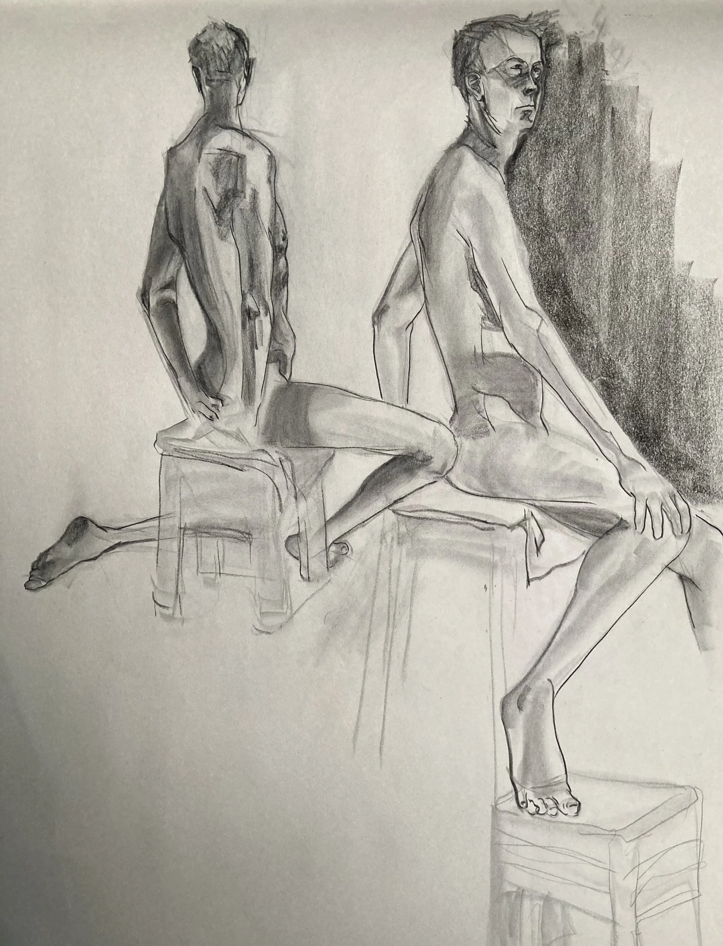 A detailed pencil sketch of a seated nude woman viewed from behind and to the side, with a shadowed background and a small table or pedestal nearby.