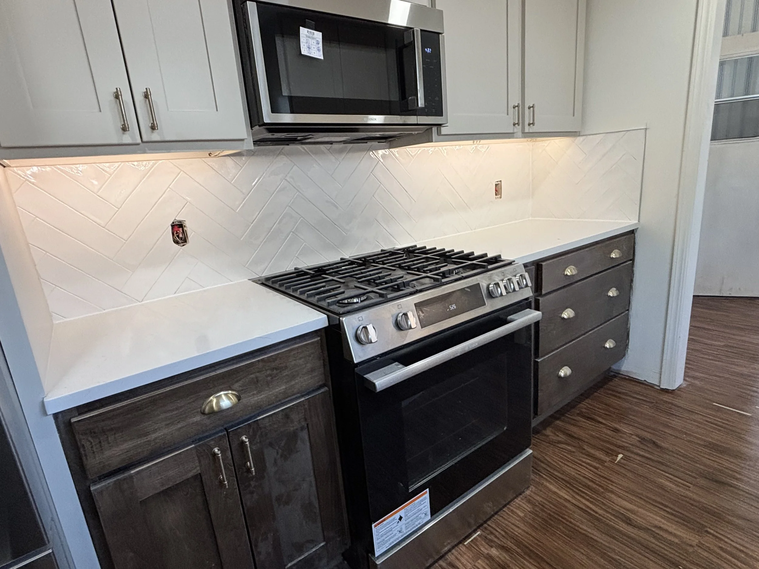 Kitchen backsplash tile in Oklahoma City. white herringbone tile pattern in kitchen.