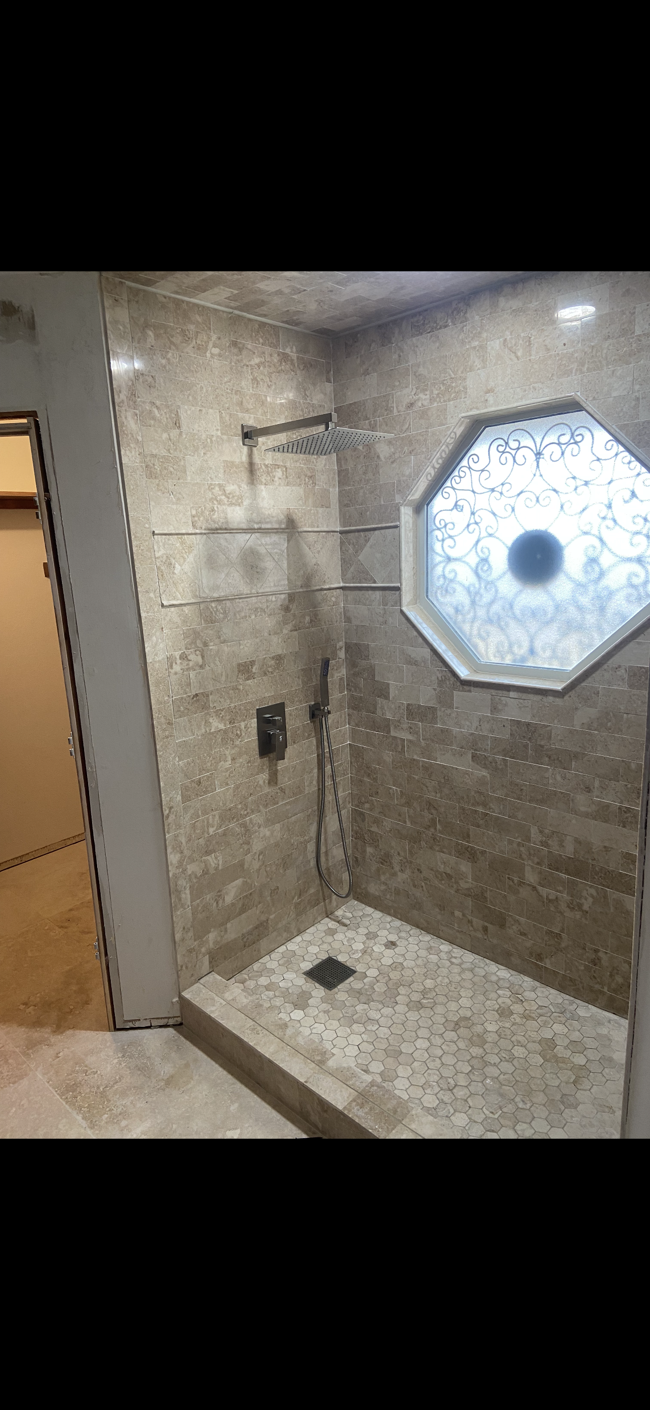 Custom tile walk in shower in Oklahoma City, OK. Custom shower pan, Window tile, decorative patterns, and custom niches.