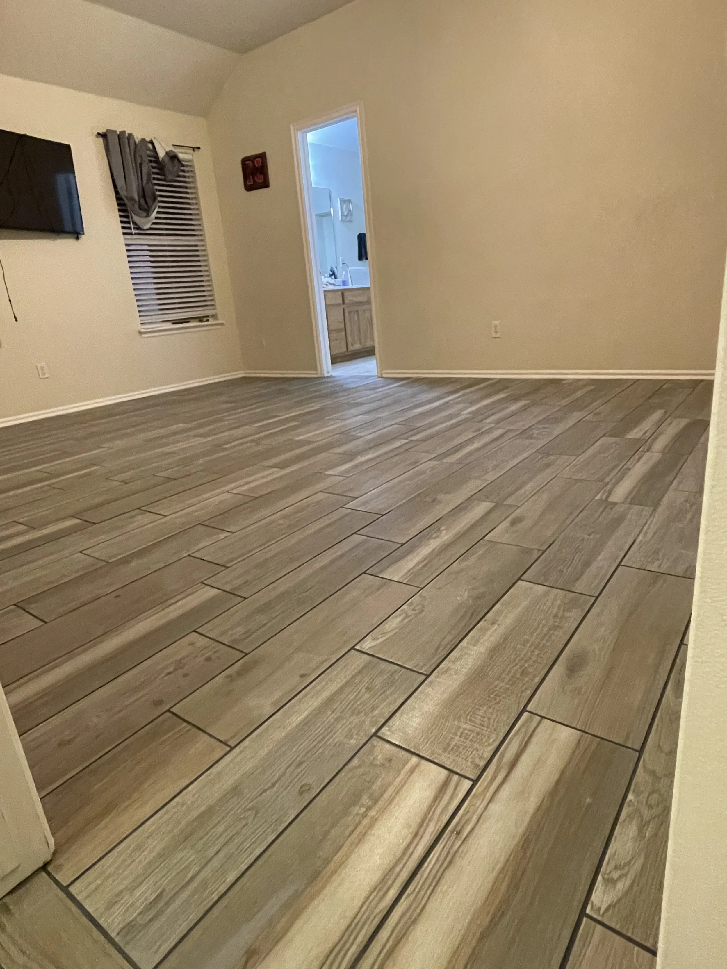 Tile flooring installation in Norman, OK. Tile flooring in a wood pattern gray in Norman, Oklahoma in 2023.