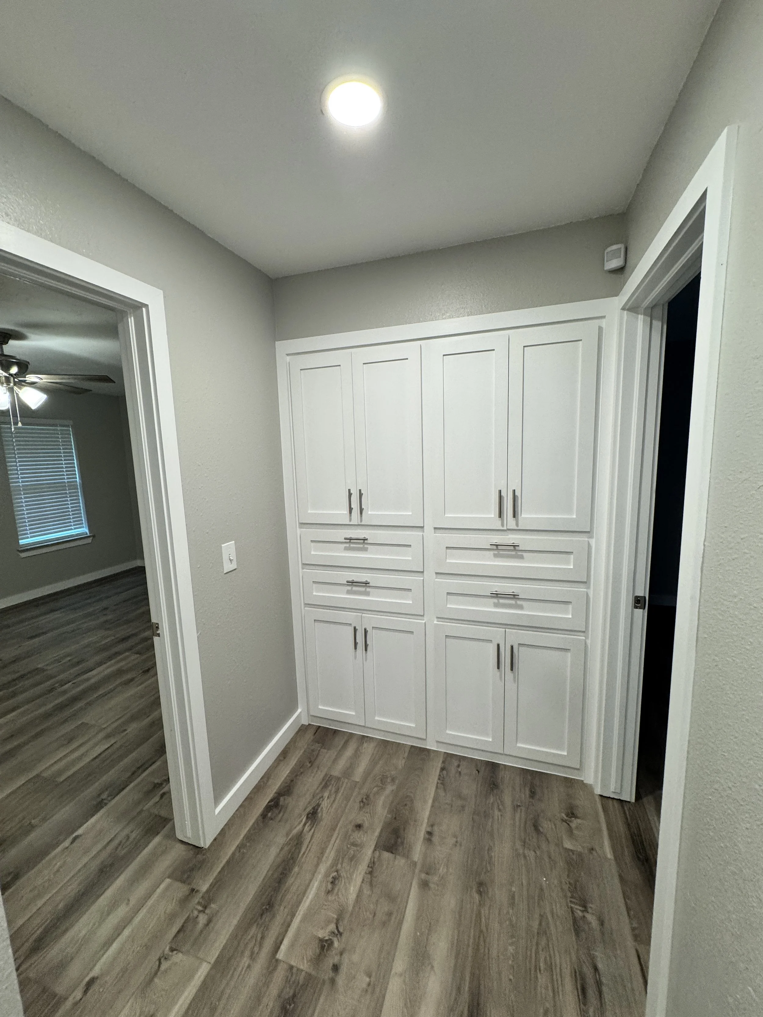 cabinet paint in Choctaw, OK. Hallway cabinets pained bright white.