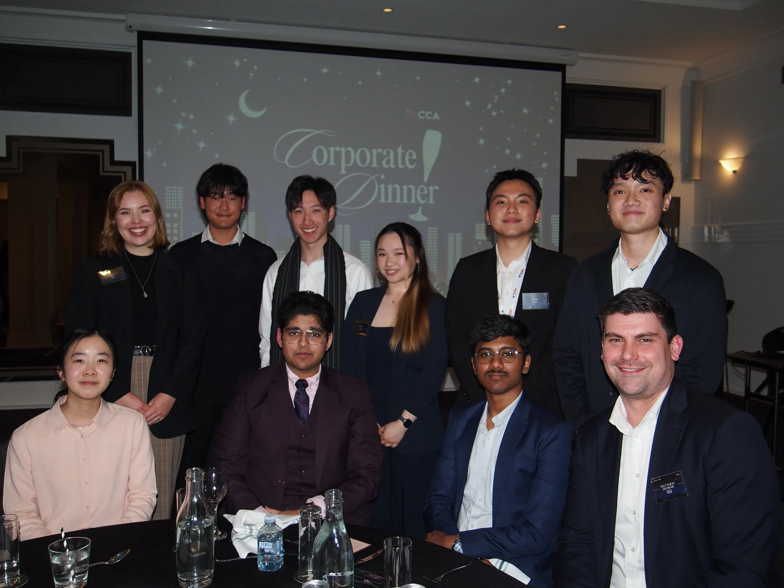 CCA Corporate Dinner: a table group photo with students and sponsors