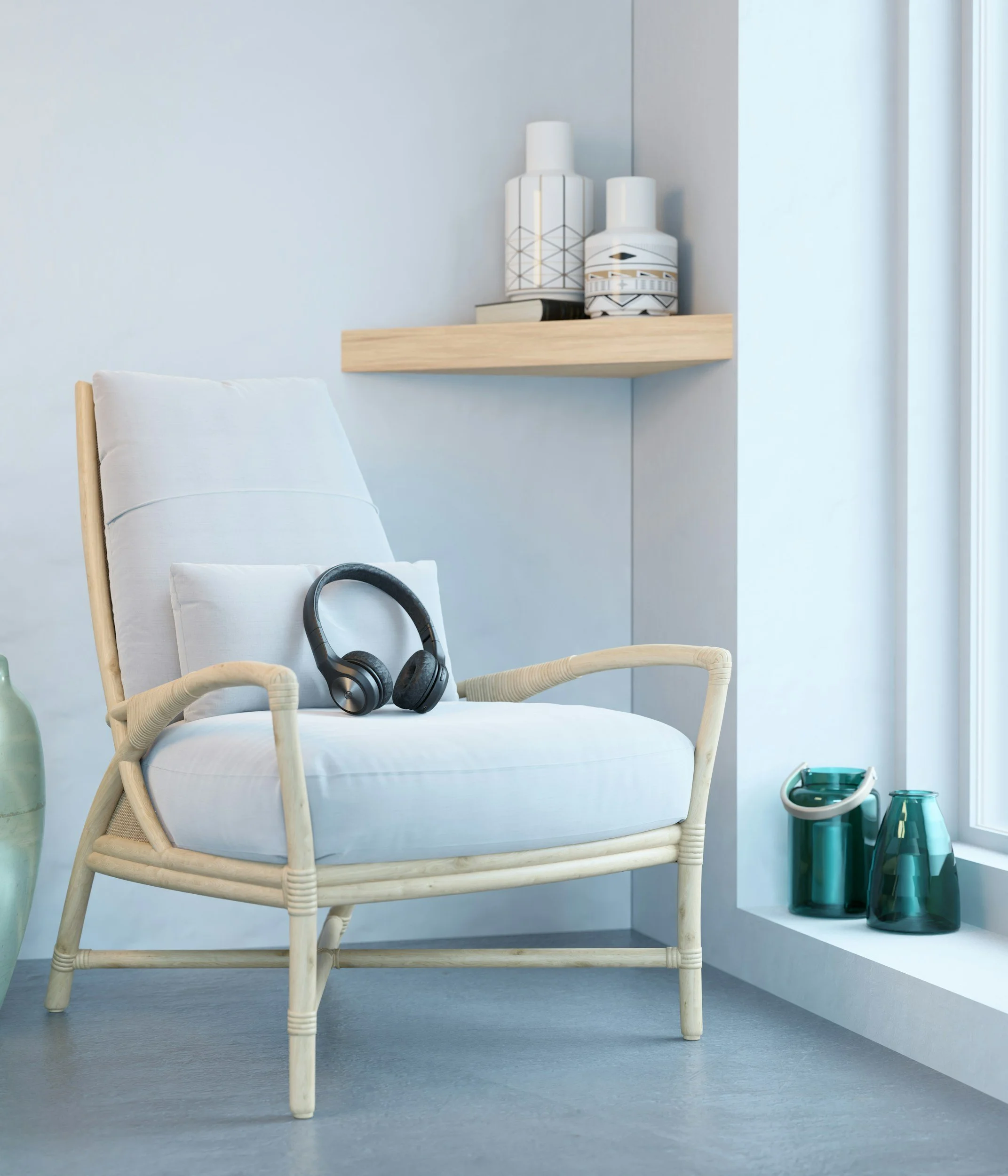 A white cushioned chair with wooden framing and armrests, a pair of black headphones resting on it, a shelf with decorative vases, and a small collection of teal-colored glass vases on a ledge by a window.
