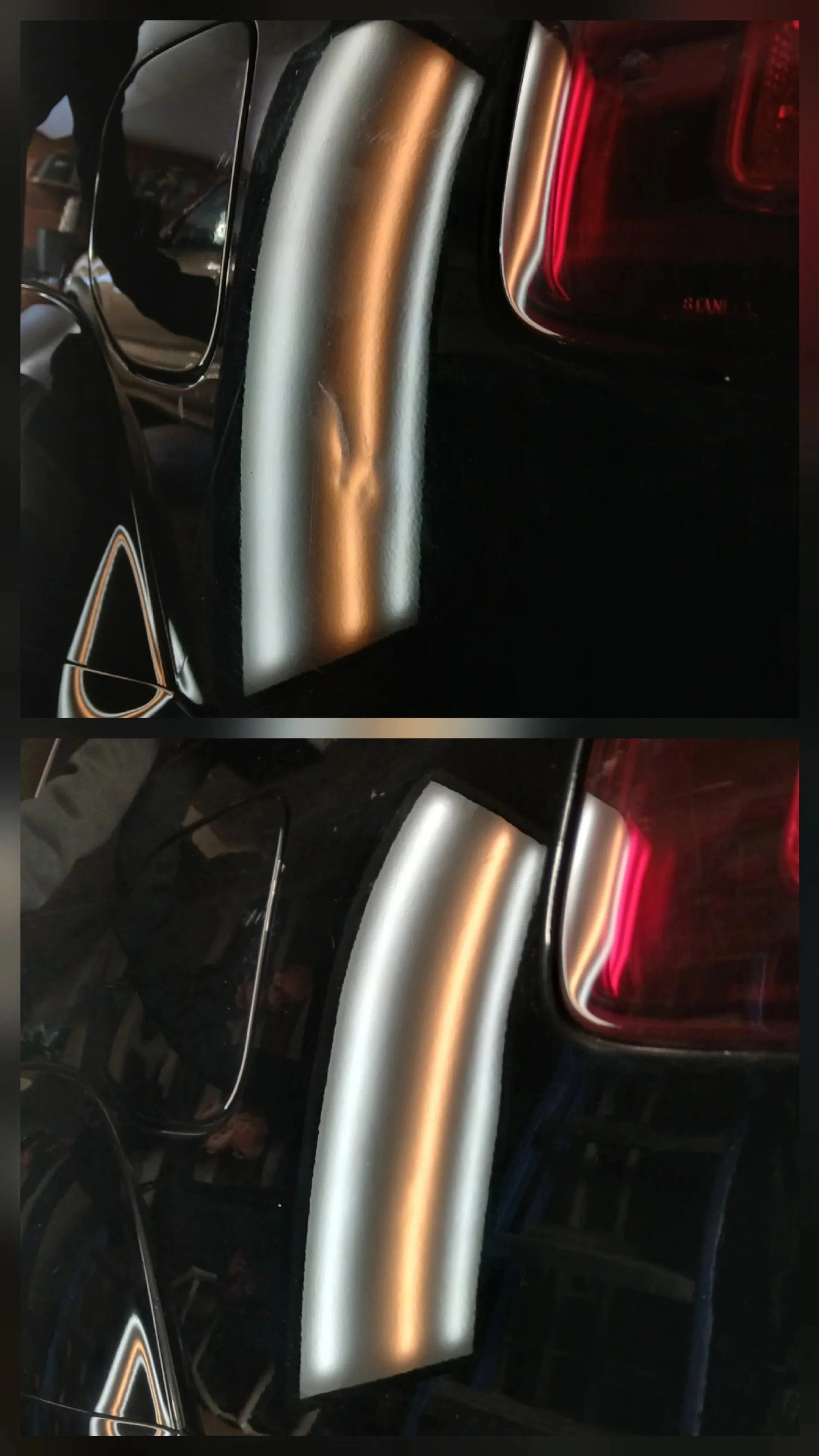 Close-up of the rear of a black car with red tail lights, reflecting the interior of a garage.