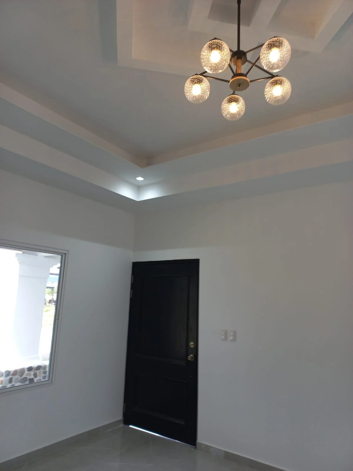 “Ceiling with modern architectural designs and decorative light fixtures that elevate the ambiance to a different level”