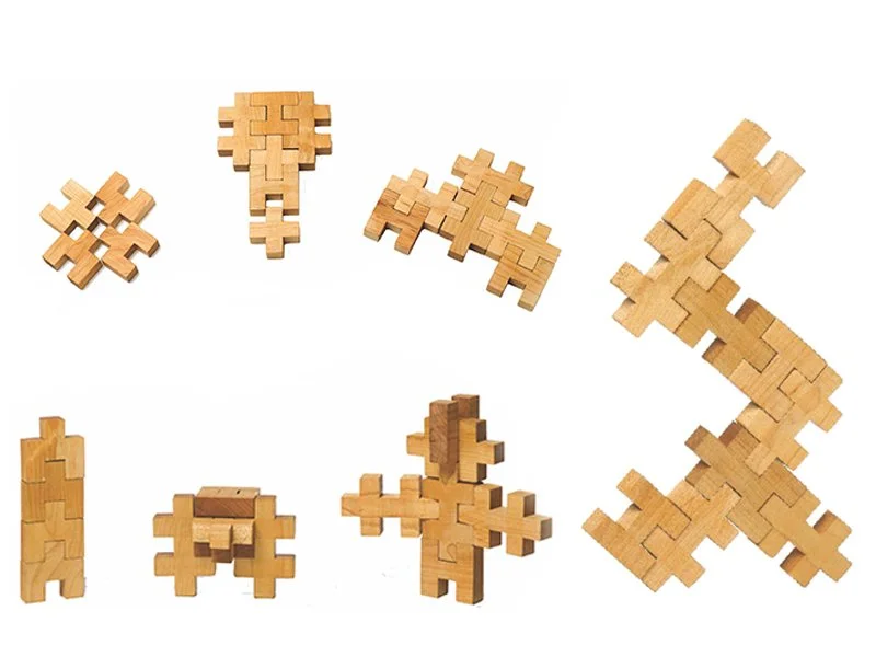 Various wooden puzzle pieces arranged randomly on a white background.