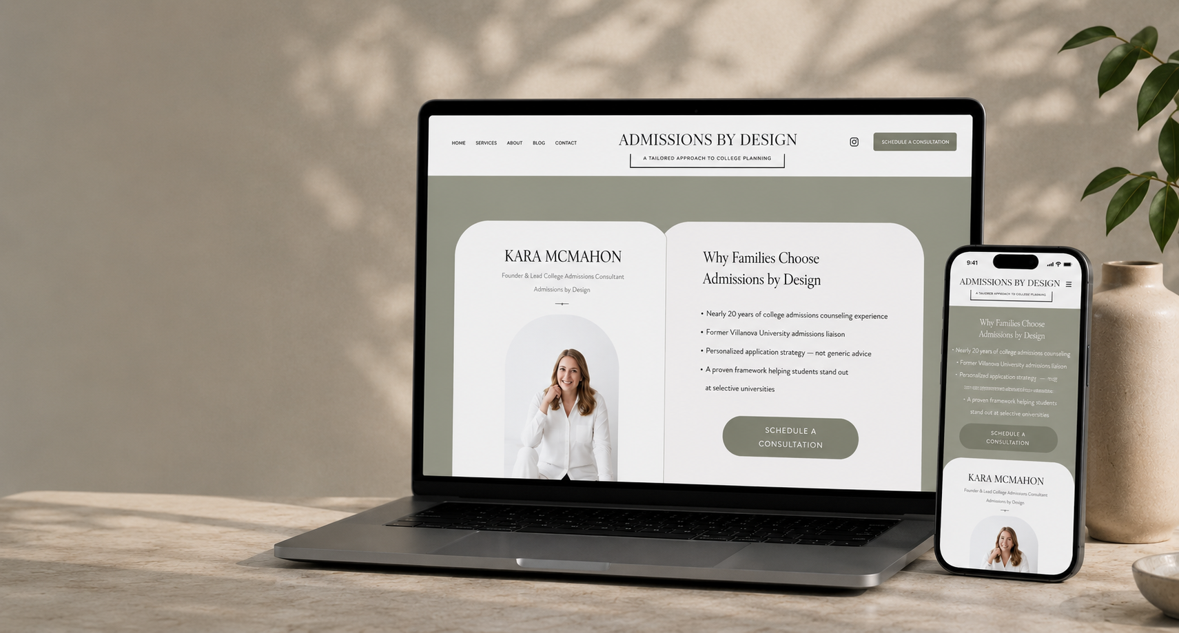 Laptop and smartphone display a website titled 'Admissions by Design' with information about college admissions consulting, featuring a photo of a smiling woman dressed in white, on a wooden table with a neutral background and a plant in a clay pot.