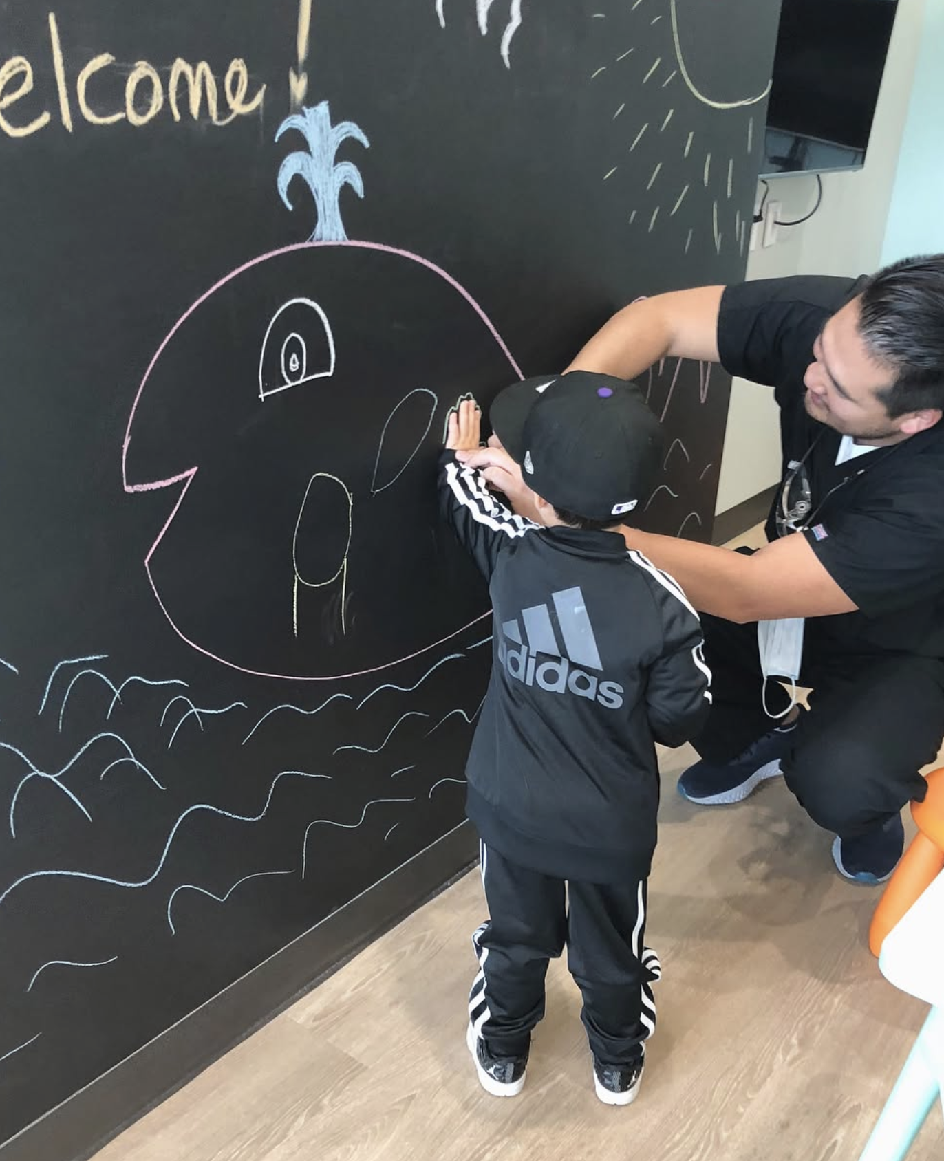 dr kwak and kid at chalkboard