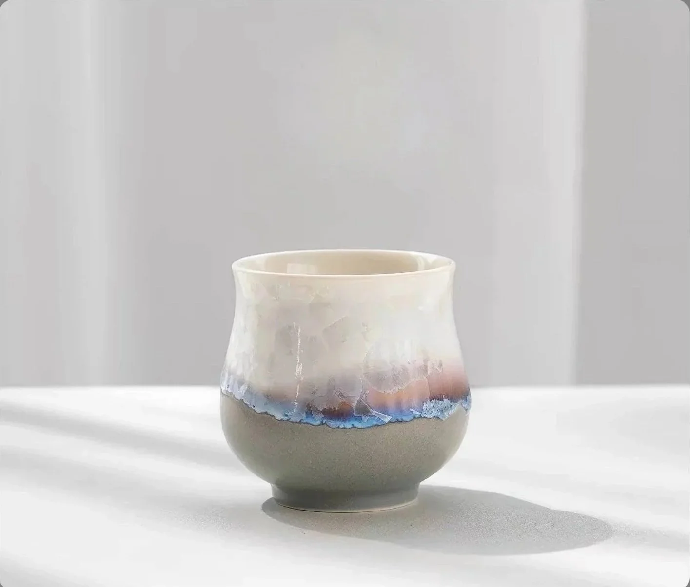 Handmade ceramic tea cup with iridescent crystal glaze and soft ocean-inspired tones, perfect for matcha, coffee, tea and minimalist table décor.