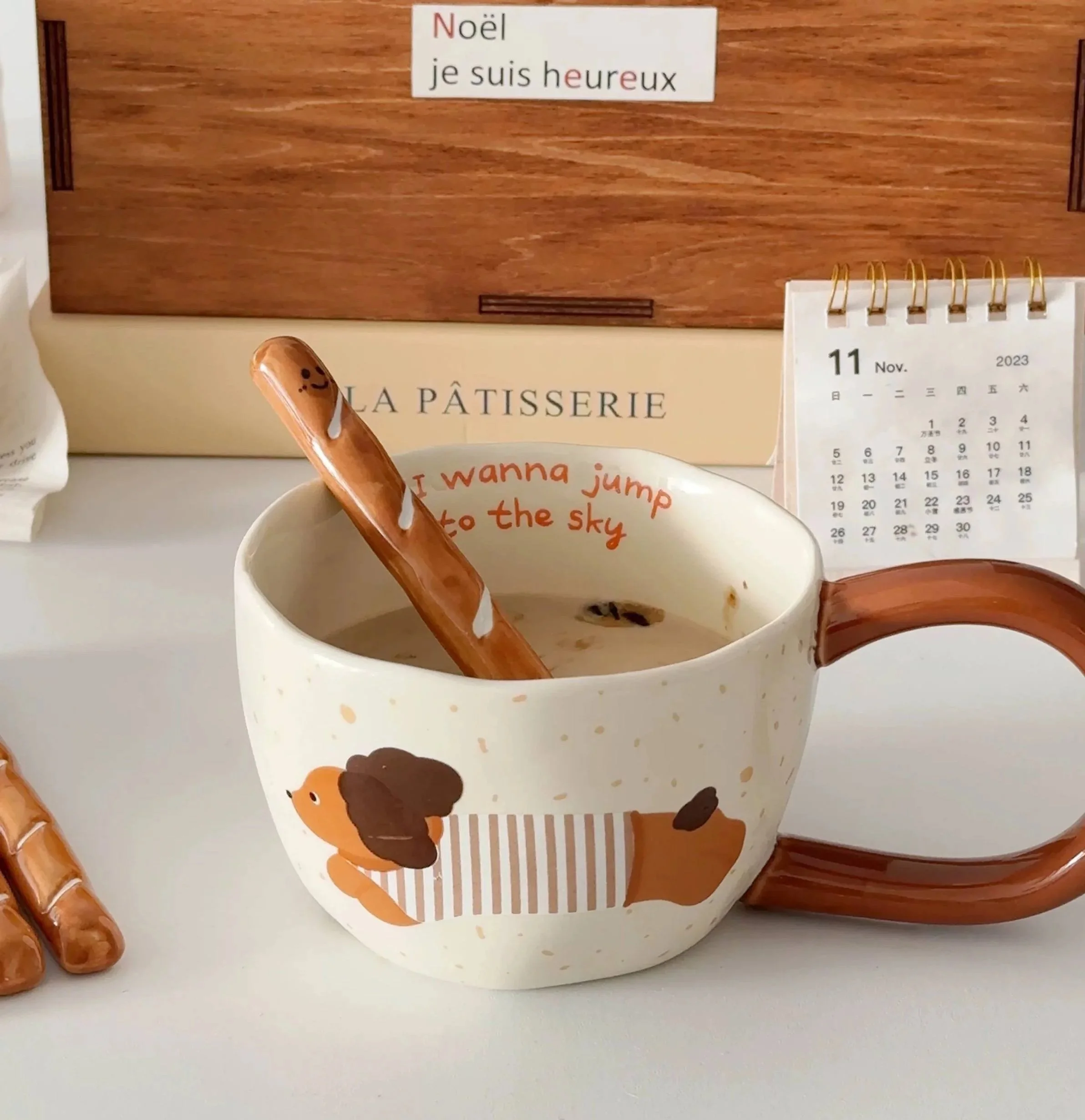 Cute baguette-shaped ceramic coffee stirrer with playful smiling face, perfect for mixing coffee, matcha and adding cosy bakery-inspired charm to your café setup.