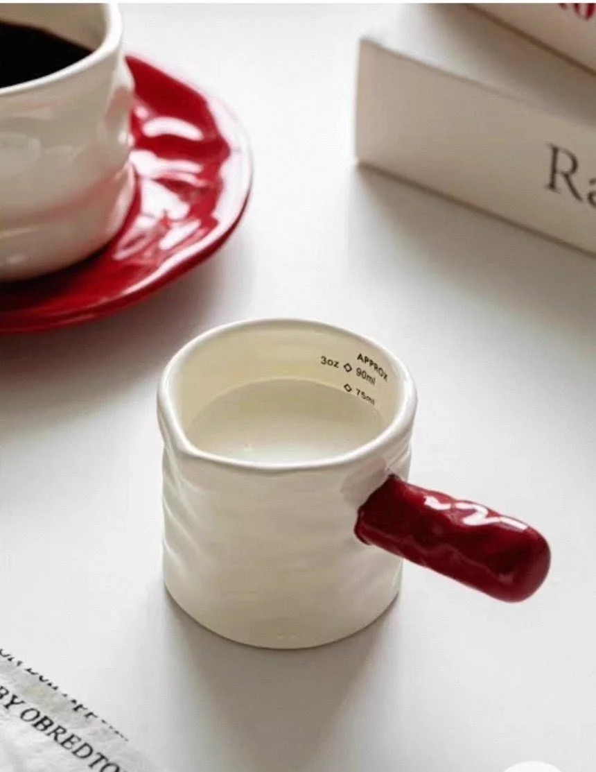 Minimalist ceramic espresso cup with glossy red handle, perfect for latte shots, milk pouring, coffee brewing and cosy modern café aesthetics.