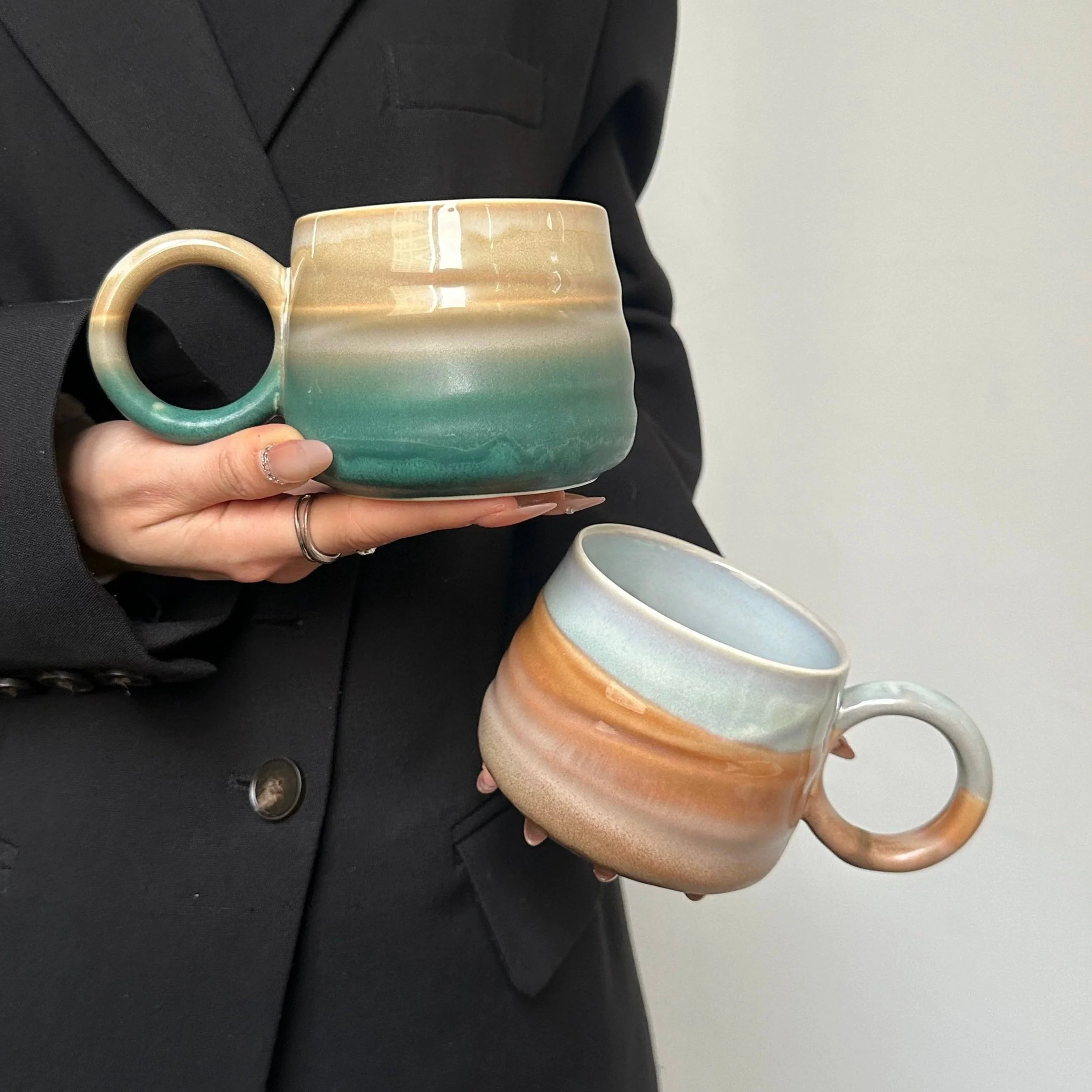 Handmade ceramic mountain mugs with earthy gradient glaze and rounded handles, perfect for cosy coffee moments and minimalist home café aesthetics.