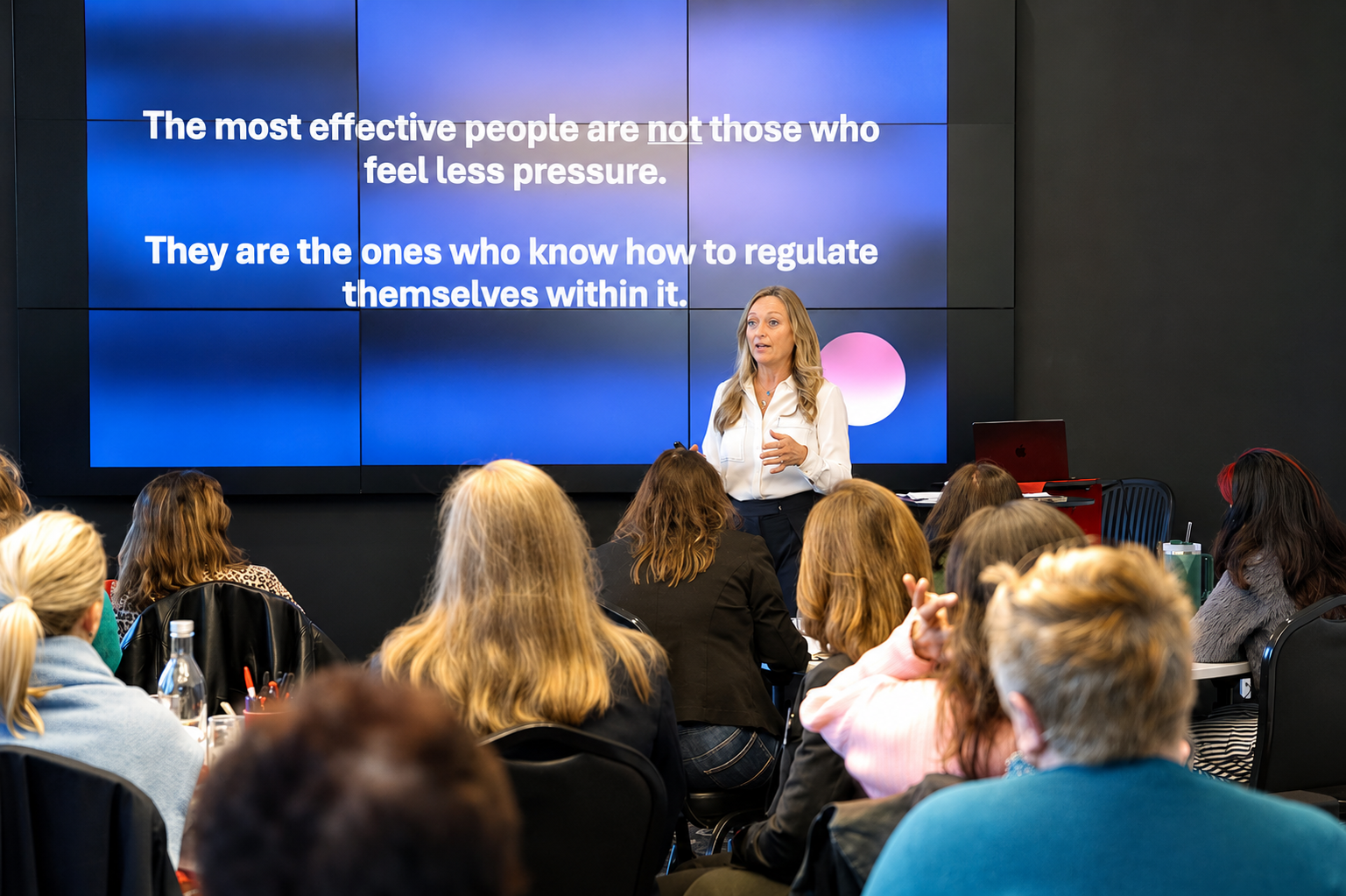 Tanya Levy presenting a keynote to a conference audience.
