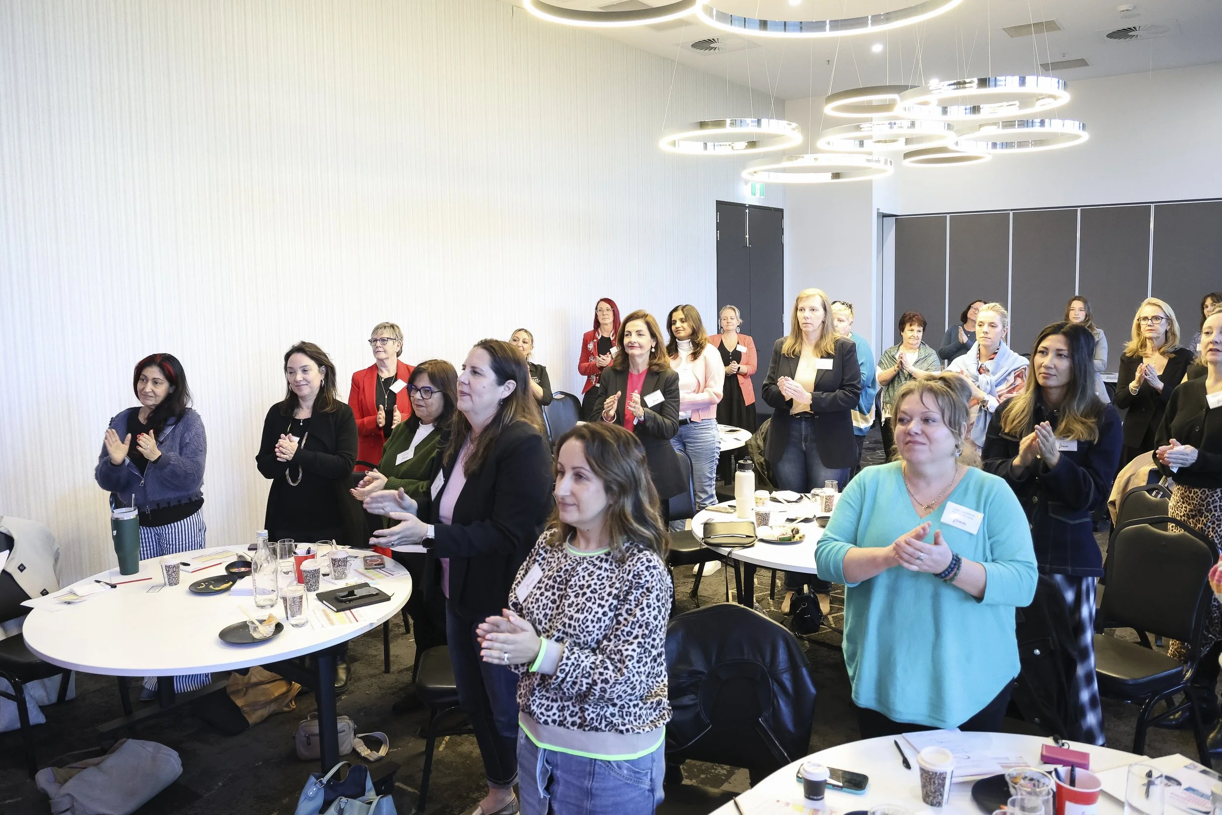 Audience clapping during an InPurpose event.