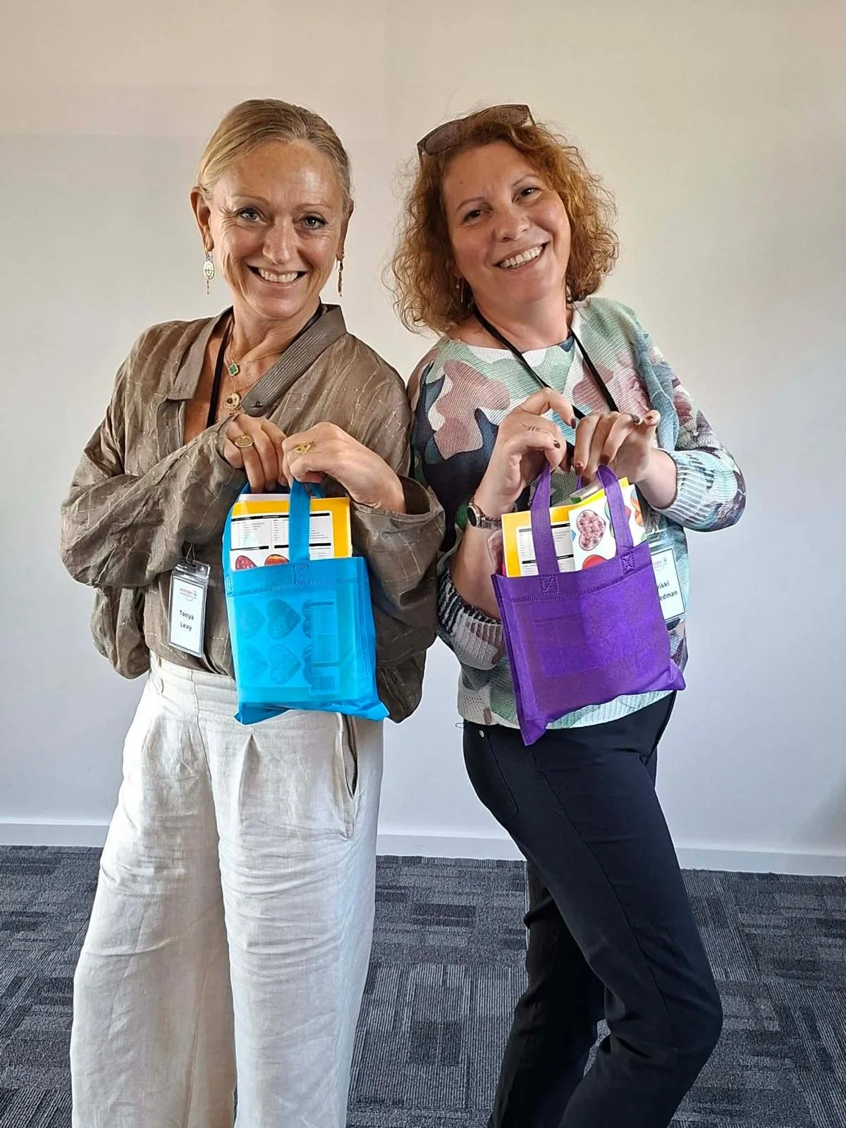 Attendees holding InPurpose retreat gift bags.