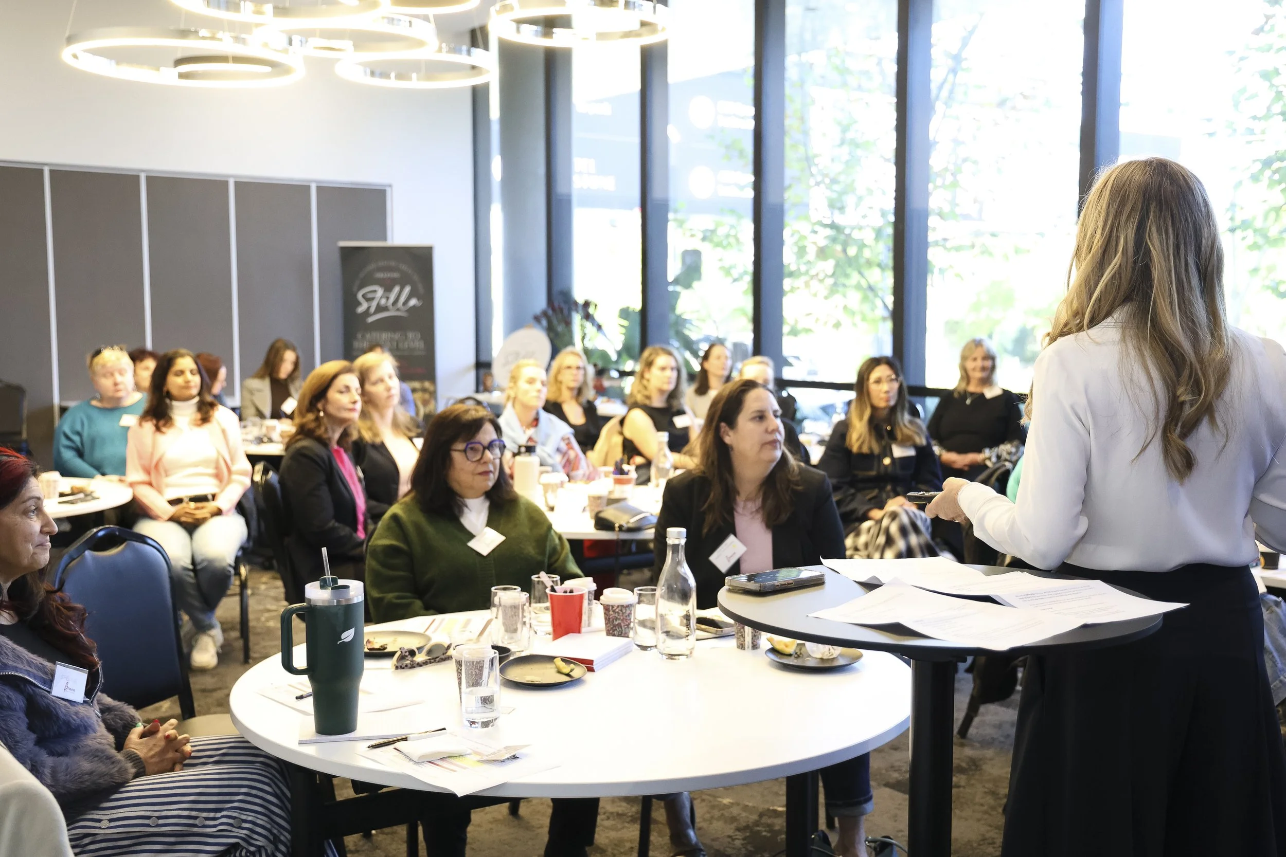 Tanya Levy presenting to a seated audience at an InPurpose event.