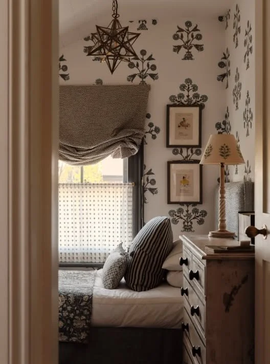 In a small bedroom, rather than disguising the size of the room, embrace it. A richly patterned large scale wallpaper creates depth and a feeling of scale. 

As part of this renovation in Richmond, we raised the floor level and vaulted the ceiling, t