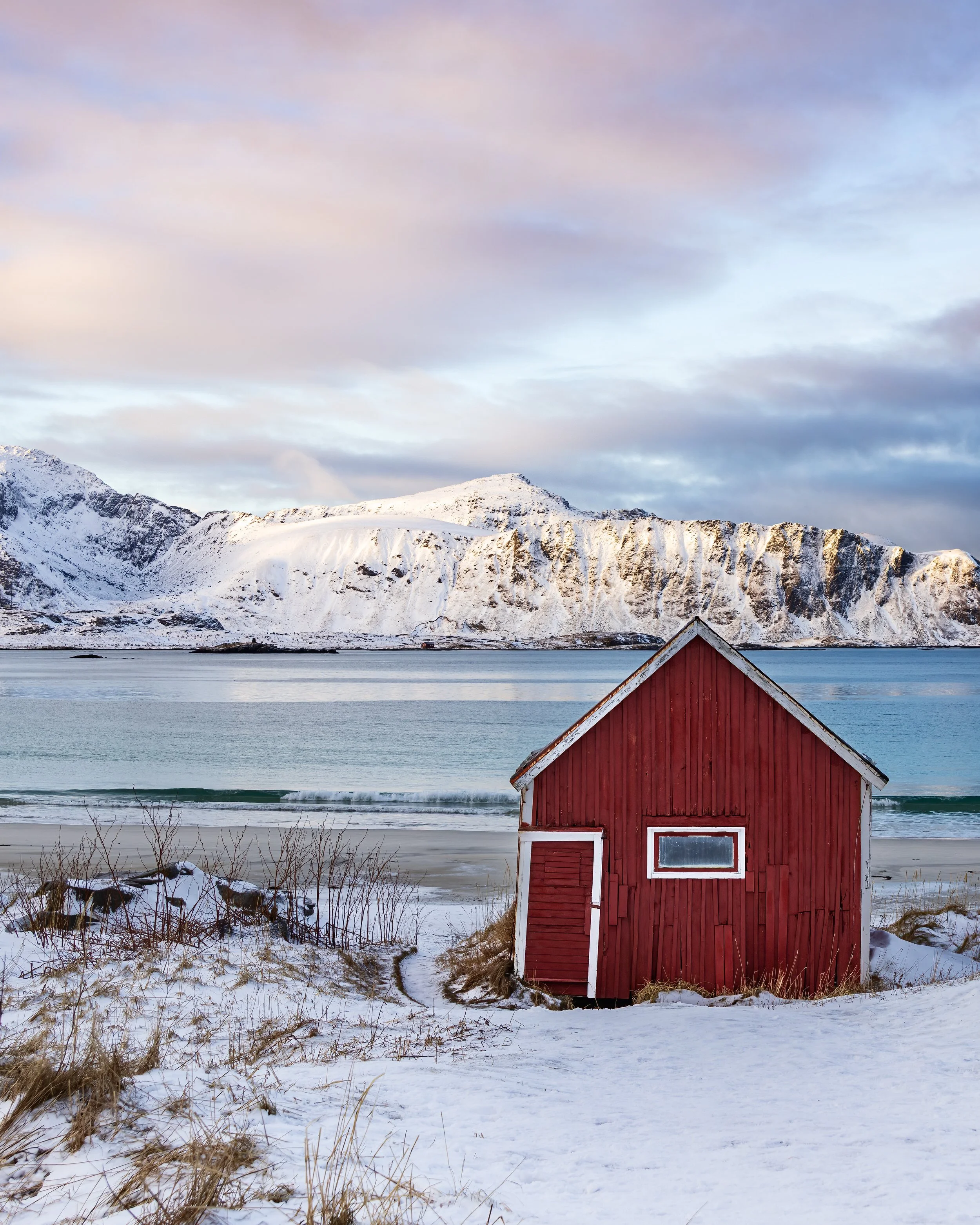 Red fisherman's cabin at Flakstadoya Island, Lofoten Islands, Norway.