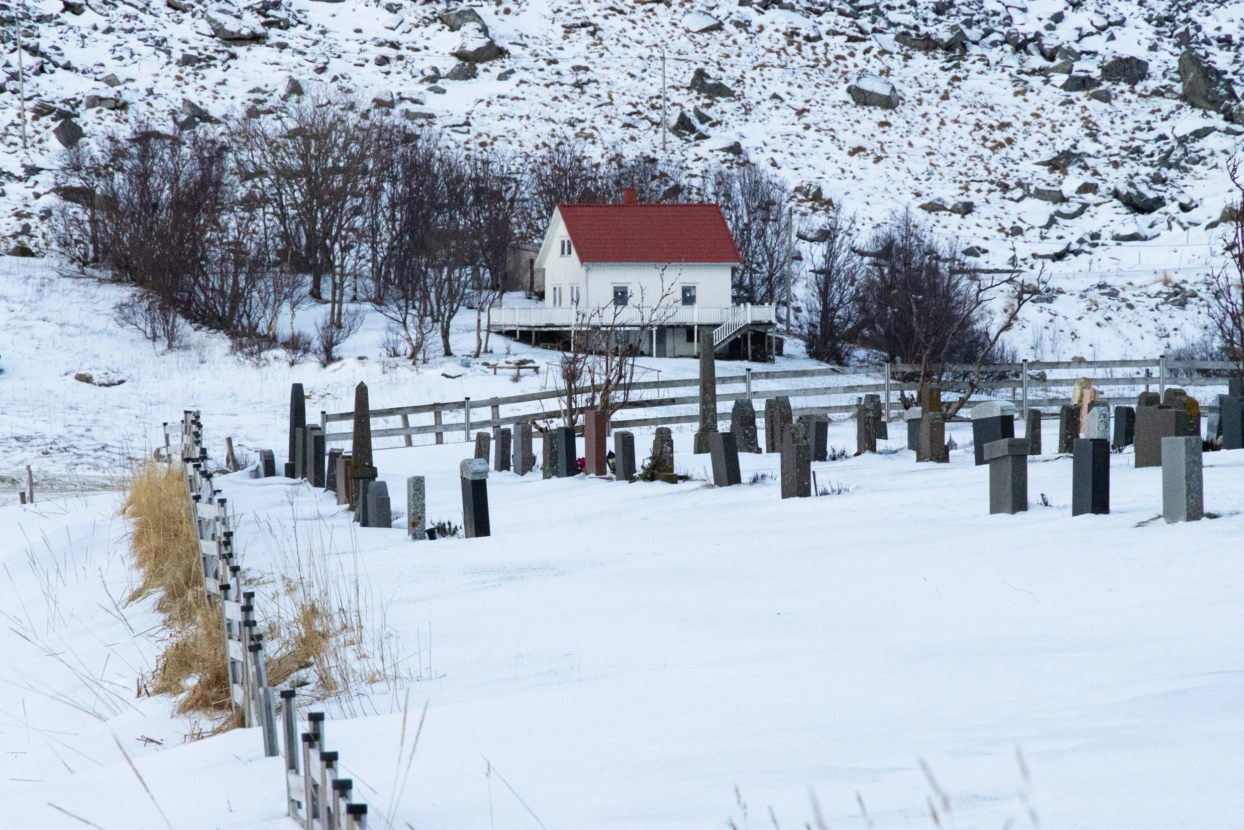 Small farmhouse Midwinter at the end of the graveyard at Vik beach Lofoten Islands, Norway.