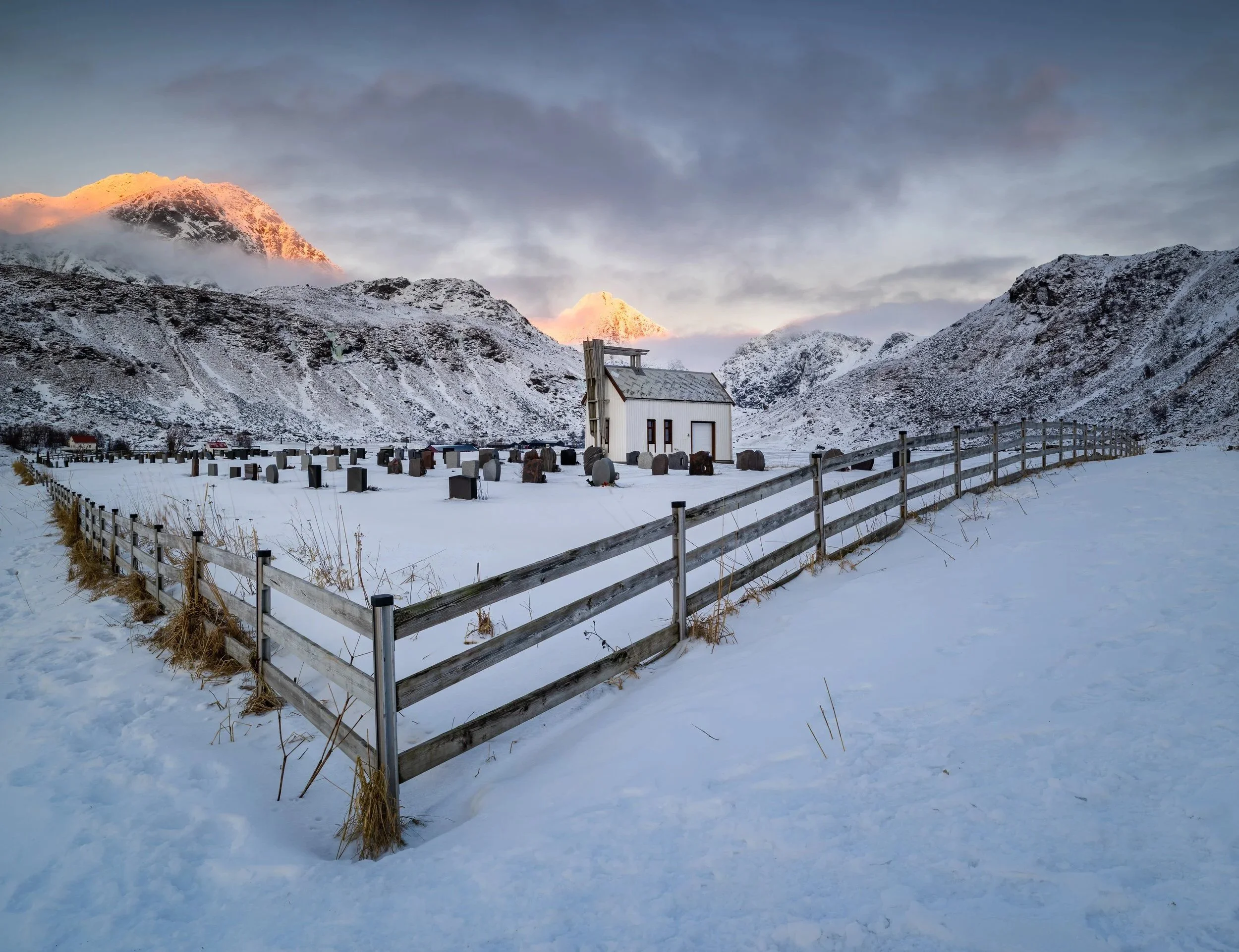Old church &amp; graveyard in Midwinter near Vik Beach in the Lofoten Islands, Norway.
