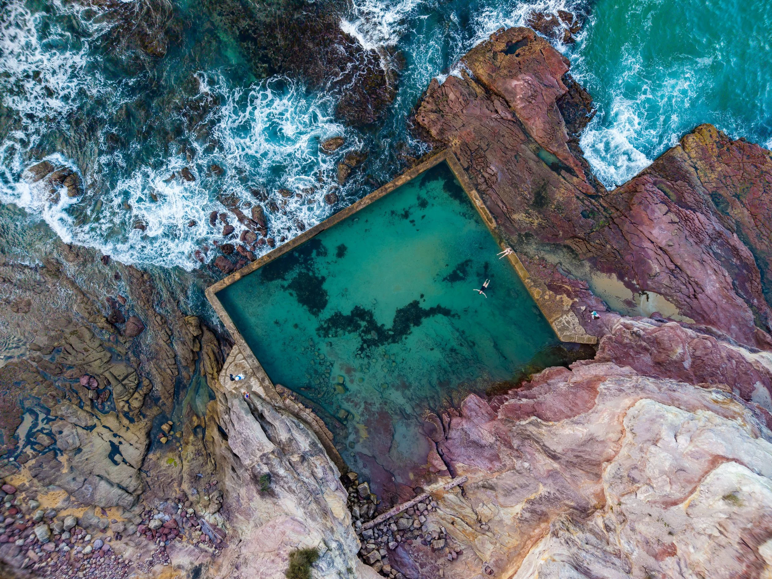 Aerial view of swimmers in the Eden Sea Baths, New South Wales, Australia.
