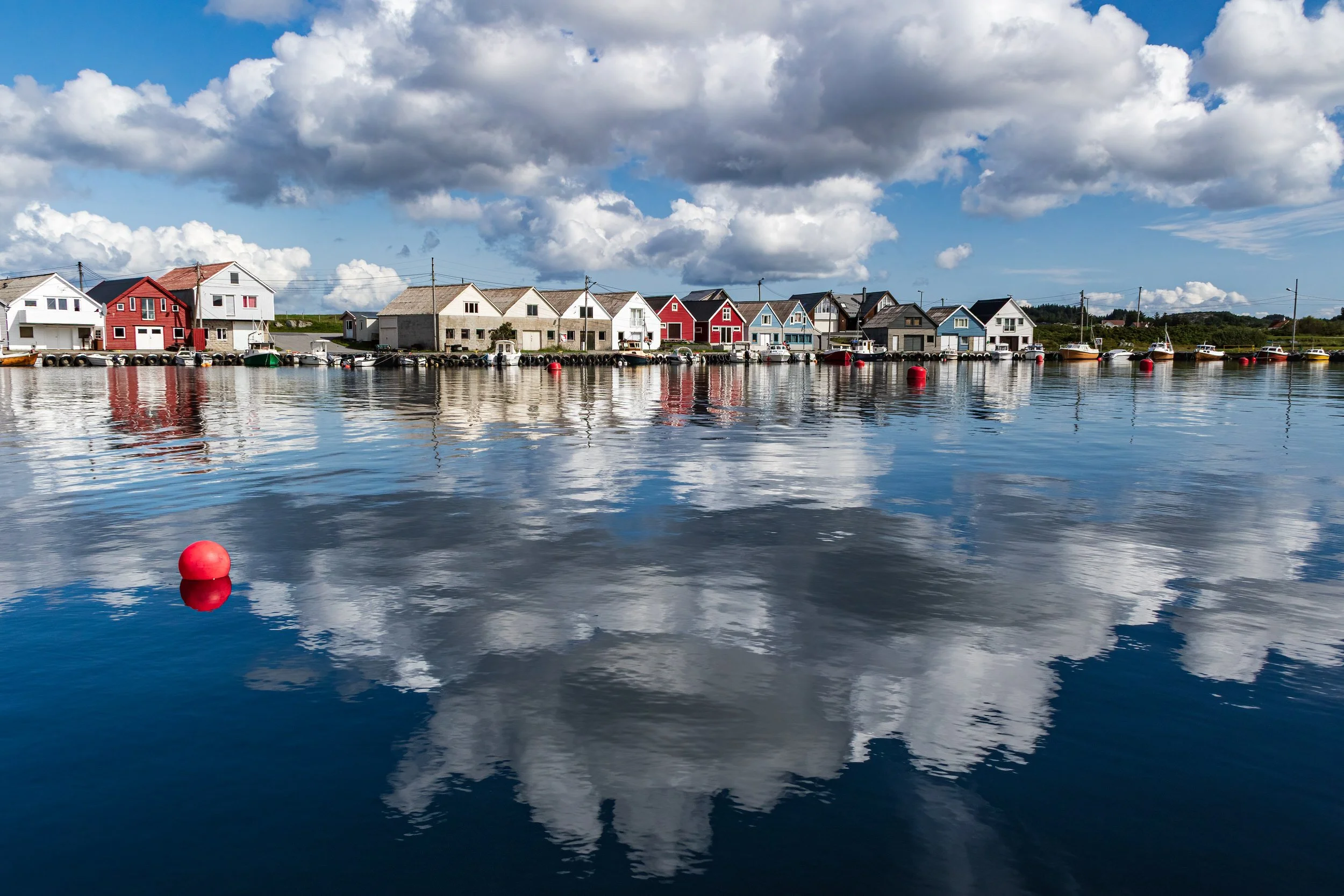 Summer reflections at the Ferkingstad Marina near Karmoy in Norway.