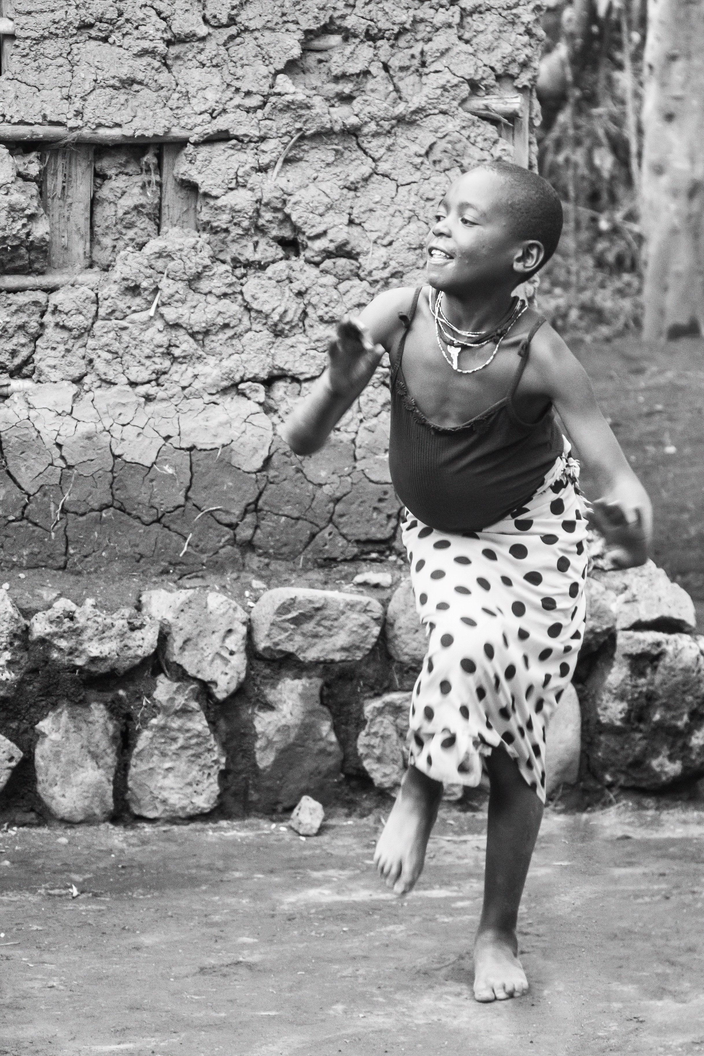 Girl dancing at a Rwandan village.