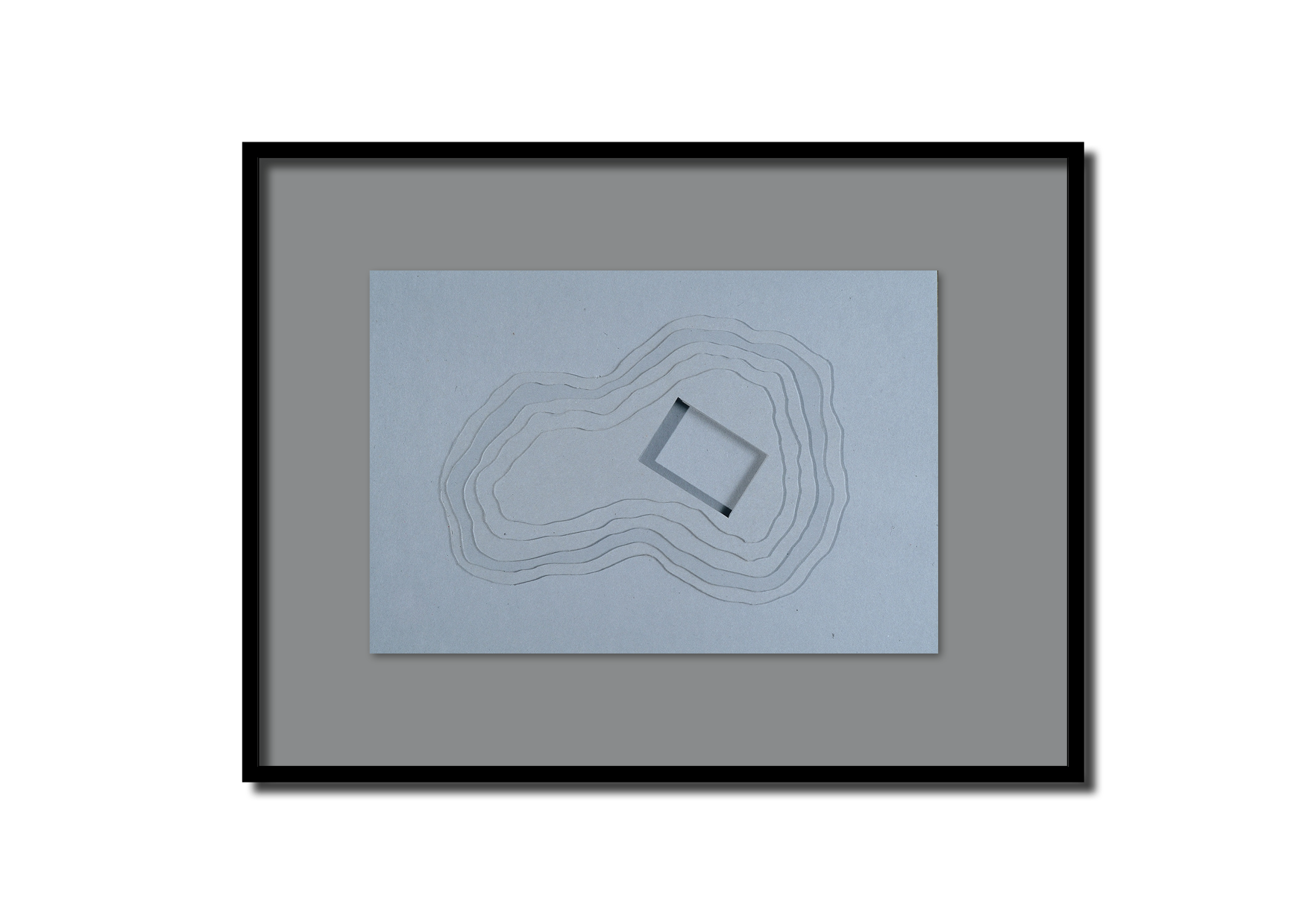 Plan architectural en relief montrant une formation géologique en forme de boucle avec un bâtiment carré placé sur la colline.